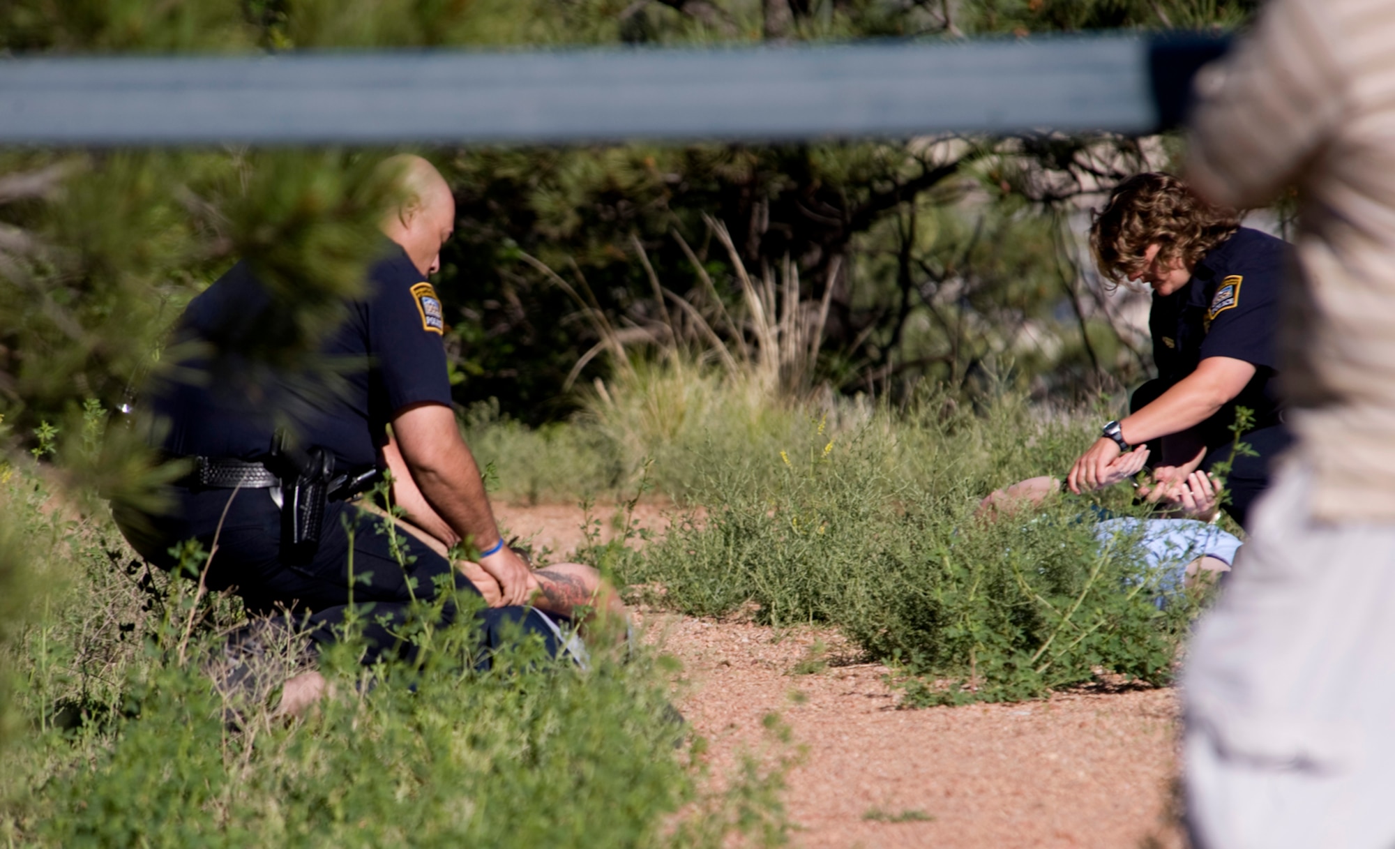 Officers from the University of Colorado at Colorado Springs take suspects into custody during the Coalition Warrior Interoperability Demonstration June 16, 2010, in Colorado Springs, Colo. (U.S. Air Force photo/Master Sgt. Jack Braden)