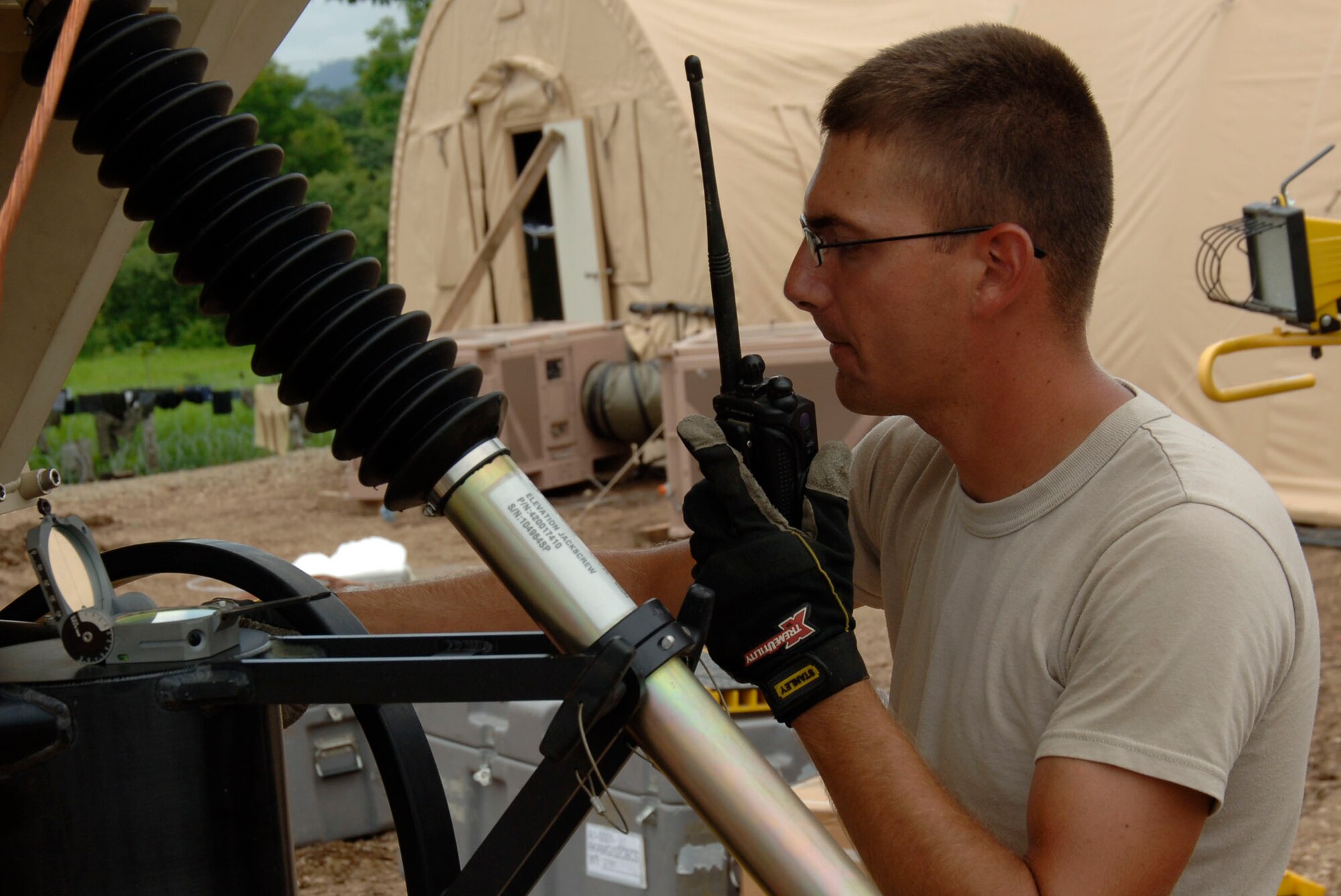 Airman 1st Class Jeffery Westmoreland, 3rd Combat Communications Group, makes the final adjustments to a communications arrary at the temporary encampment that will house more than 250 Airmen, Soldiers, and Marines for New Horizons Panama 2010. (U.S. Air Force photo/Tech. Sgt. Eric Petosky)