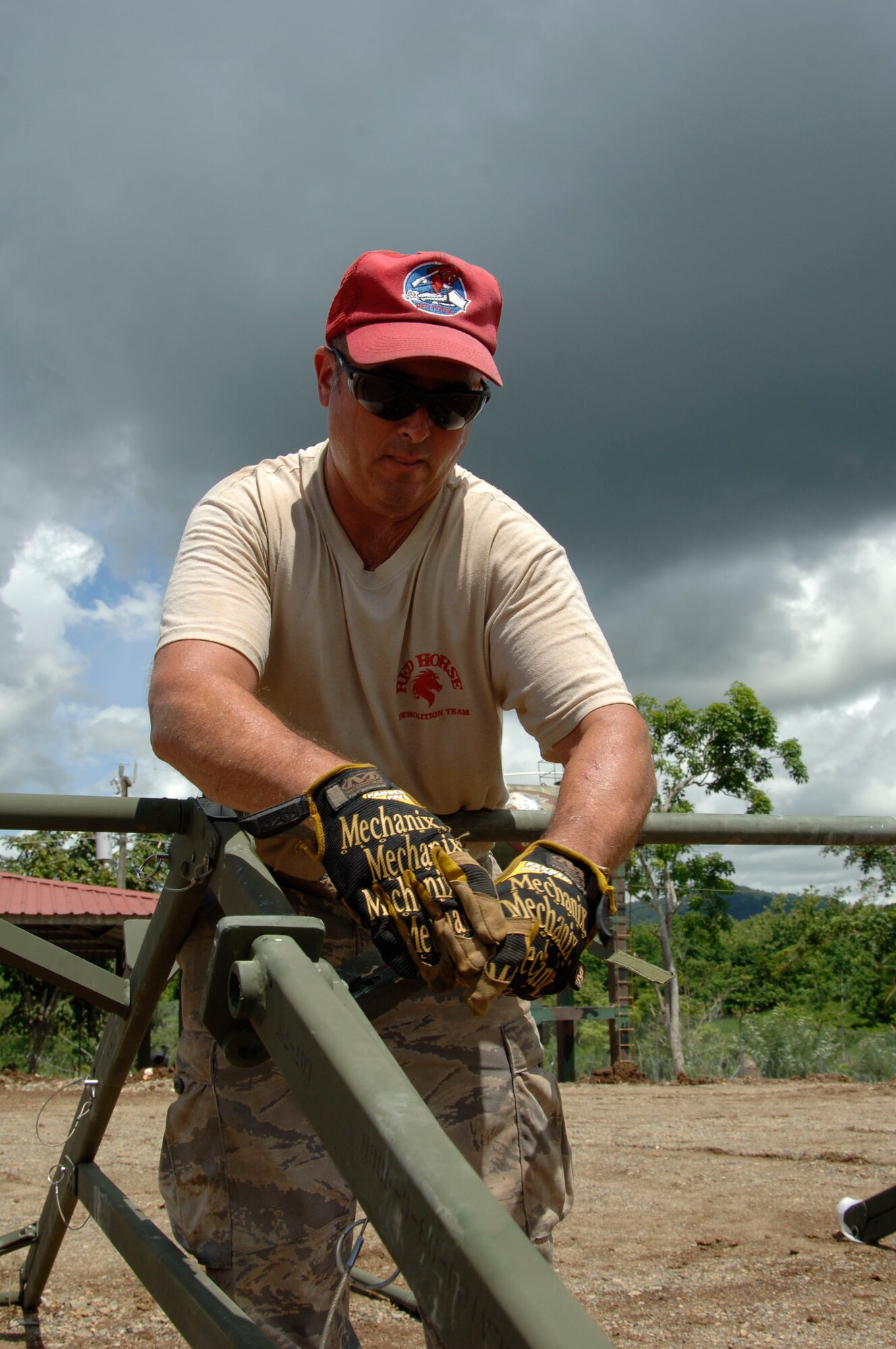 Tech. Sgt. Dave Chartier, 567th RED HORSE Squadron, puts together the roof of the dining tent at the temporary encampment that will house more than 250 Airmen, Soldiers, and Marines for New Horizons Panama 2010. (U.S. Air Force photo/Tech. Sgt. Eric Petosky)