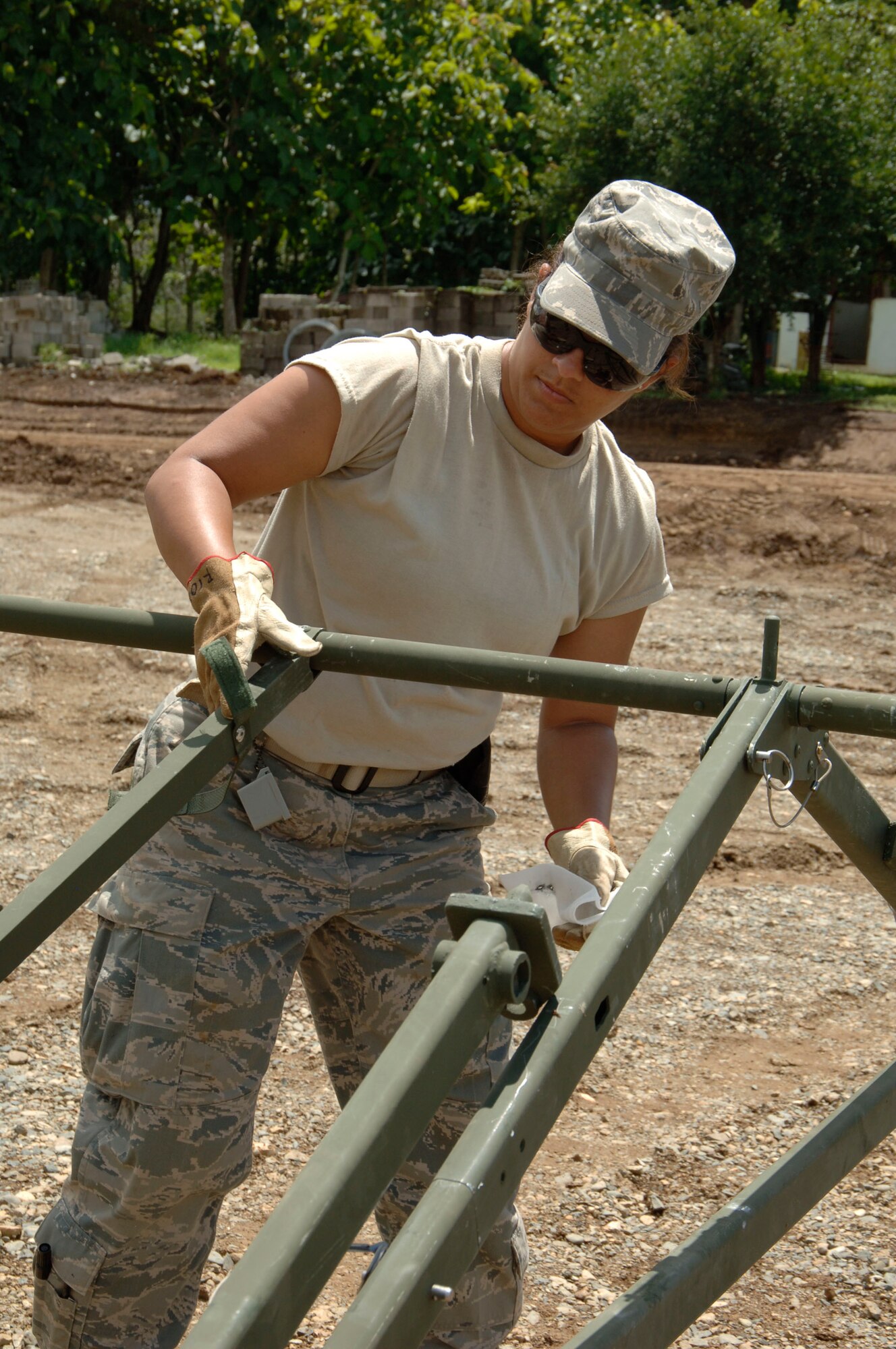 Master Sgt. Sol Rios, 567th RED HORSE Squadron, puts together the roof of the dining tent at the temporary encampment that will house more than 250 Airmen, Soldiers, and Marines for New Horizons Panama 2010. (U.S. Air Force photo/Tech. Sgt. Eric Petosky)