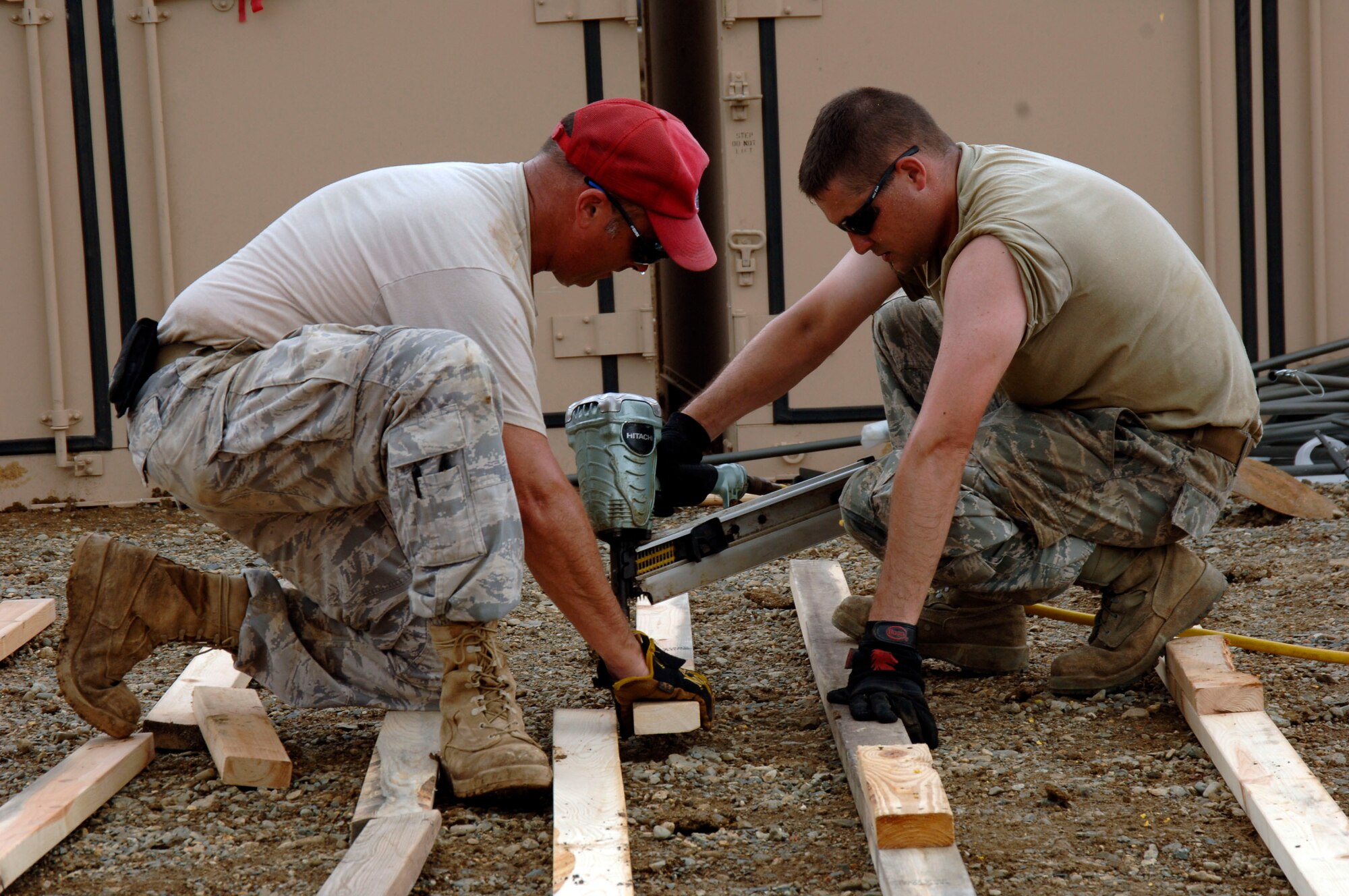 Tech Sgt. Dave Chartier (left) and Staff Sgt. Shane Evenden, 567th RED HORSE Squadron, construct the floor for the dining tent at the temporary encampment that will house more than 250 Airmen, Soldiers, and Marines for New Horizons Panama 2010. (U.S. Air Force photo/Tech. Sgt. Eric Petosky)