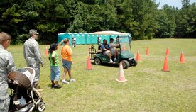 Airmen and family members wait their turn to try the "drunken driving simulation" using beer goggles which simulate a drunken affect at the annual base picnic June 11, 2010 on Joint Base Charleston, S.C. The 628th Air Base Wing safety office setup and sponsored the simulation which offered a controlled look into drunken driving and the effects alcohol has on your reaction time and motor skills. (U.S. Air Force photo/Senior Airman Timothy Taylor)