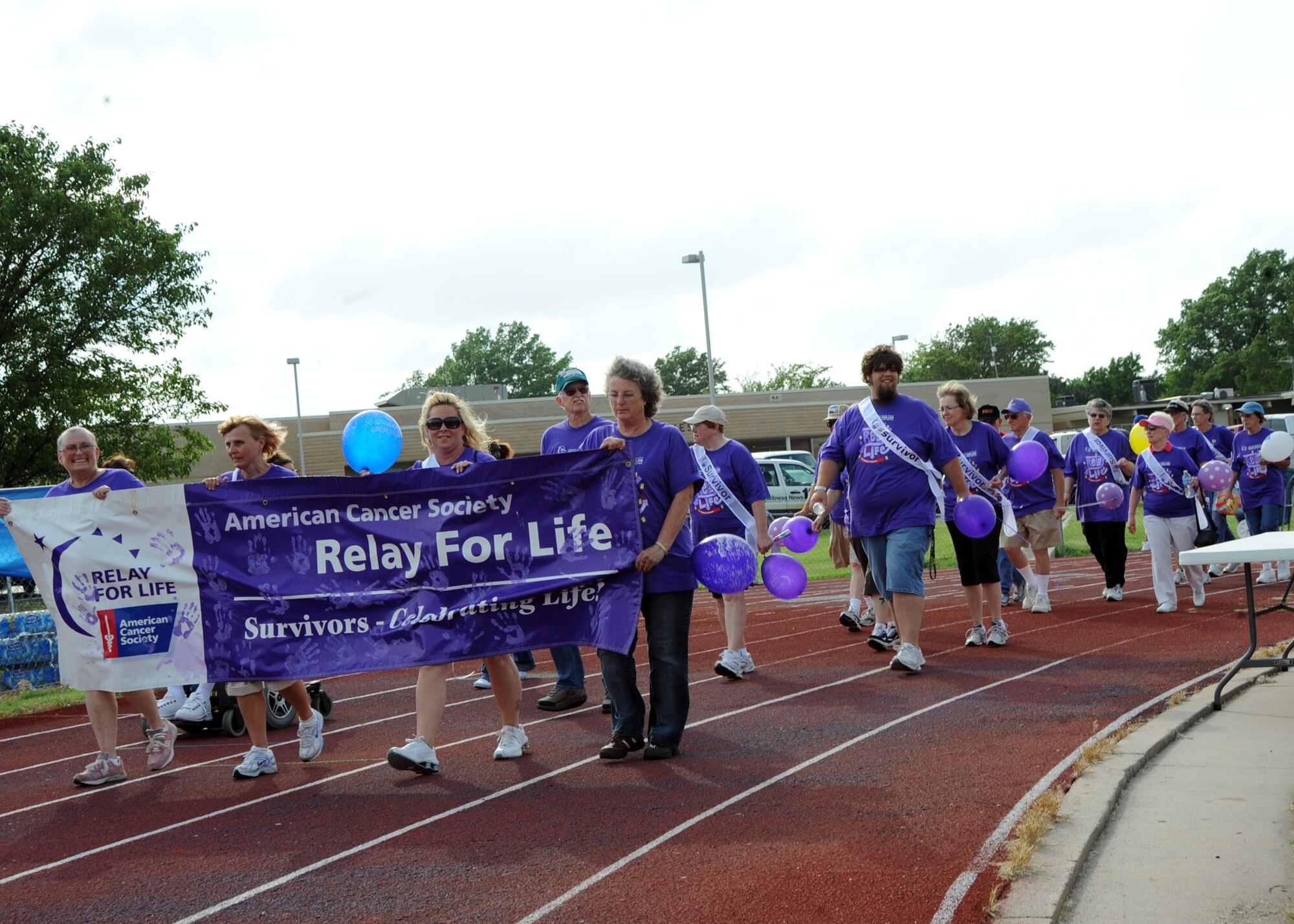 Cancer survivors circle around a track during the American Cancer Society “Relay for Life” held at the Wichita Collegiate High School, June 11, 2010, Wichita, Kan.  The relay starts with a “Survivors Lap,” where survivors are invited to circle the track together to celebrate the victories they’ve achieved battling cancer.  Members of Team McConnell and residents from Wichita participated in “Relay For Life” to pay tribute to the lives lost to the disease, and to help raise money for future cancer research.  (U.S. Air Force photo/Airman 1st Class Andrea Salazar