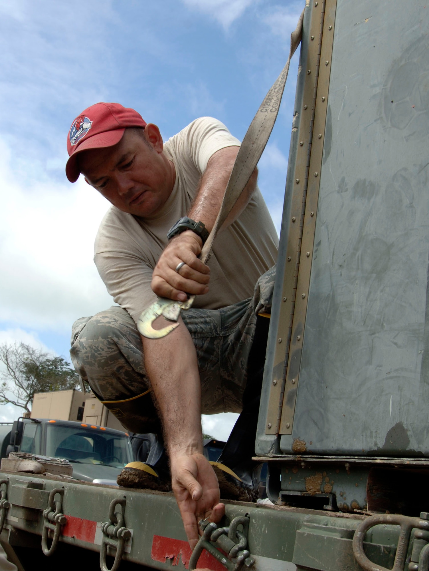 Master Sgt. Oziel Cano, 820th RED HORSE Squadron, secures a cargo container to a flatbed truck destined for the temporary encampment that will house more than 250 Airmen, Soldiers, and Marines for New Horizons Panama 2010. (U.S. Air Force photo/Tech. Sgt. Eric Petosky)