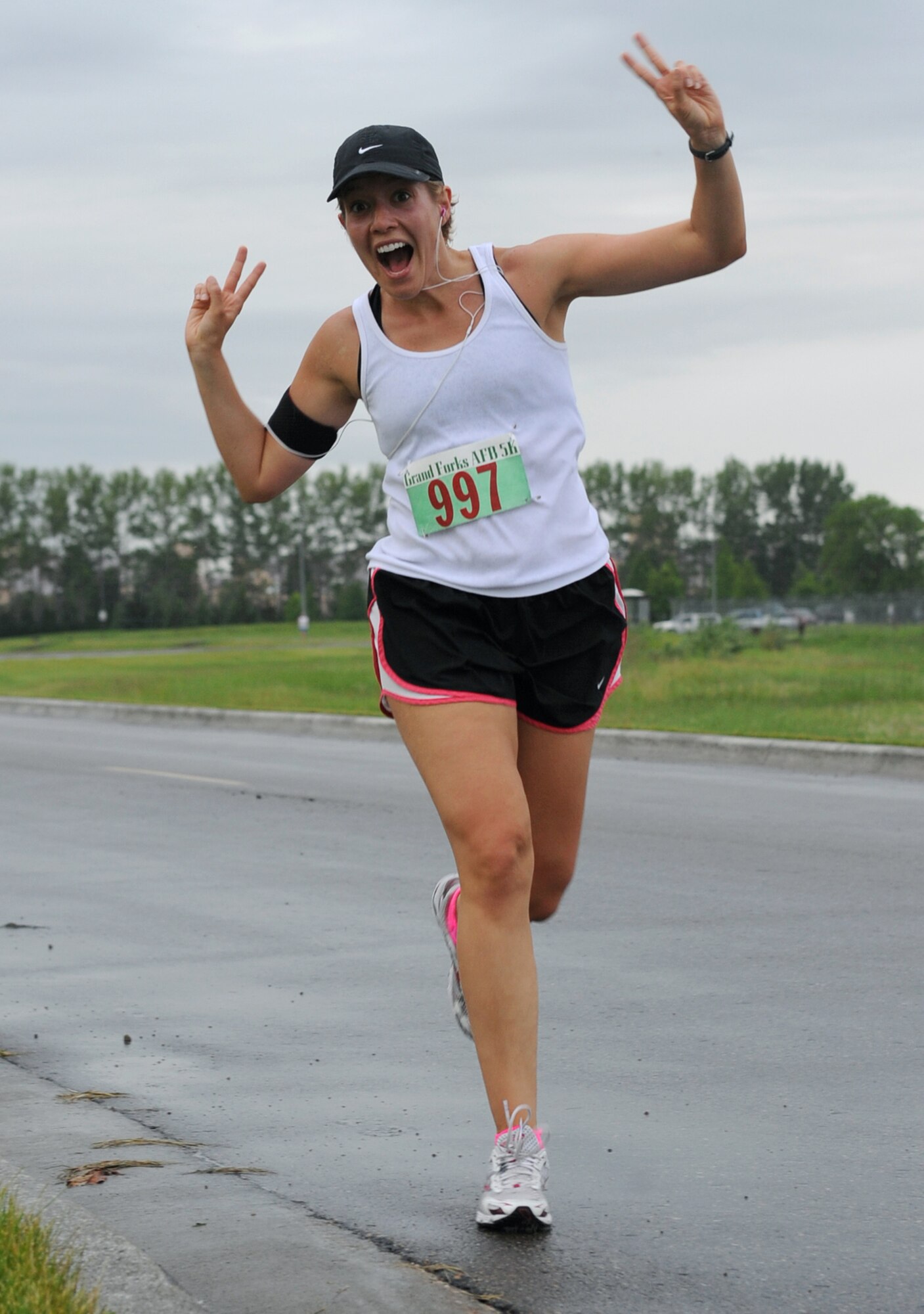 2nd Lt. Anna Hall, 319th Operations Support Squadron, shows her enthusiasm for running during the Grand Forks Air Force Base Half-Marathon, June 15. This marathon is just one of the Fitness Center’s special events that are held every year. (U.S. Air Force photo by Airman 1st Class Amber Price)