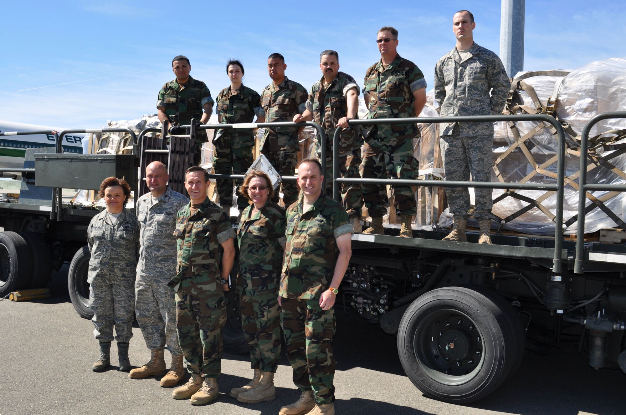 TRAVIS AIR FORCE BASE, Calif. -- Routinely, during the 349th Air Mobility Wing unit training assembly, the U.S. Navy comes here to train with the experts at the 45th Aerial Port Squadron. Front and center, Capt. Daniel R. Pionk, commodore of the Fifth Navy Expeditionary Logistics Regiment, Point Mugu, Calif., brings his warriors to train because he says Travis has a great facilities and equipment to provide quality training for his warriors who pack and move cargo around the world. Here they are on a 60K "Tunner" loader with 45th APS Commander, Maj. Cary Simpson, left of the captain, and some of his "Port Dawgs." (U.S. Air Force photo/Senior Master Sgt. Ellen L. Hatfield)