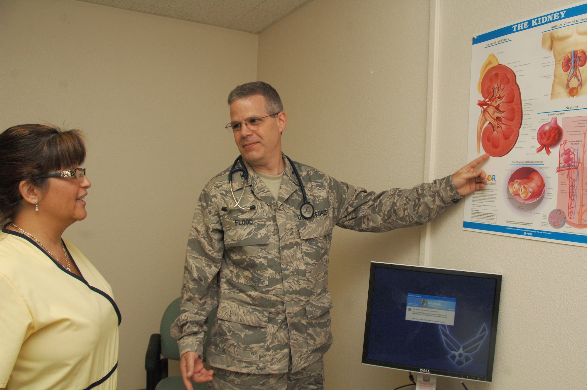 Col. (Dr.) Kevin Flood, nephrology fellow; and Ms. Michelle Ohlinger, hemodialysis technician; both from the 59th Medical Operations Squadron, discuss kidney function on June 11 at Wilford Hall Medical Center, Lackland Air Force Base, Texas.  Wilford Hall?s nephrology fellowship program has tied for second place in the nation. (U.S. Air Force photo by Senior Airman Nicole Mickle)