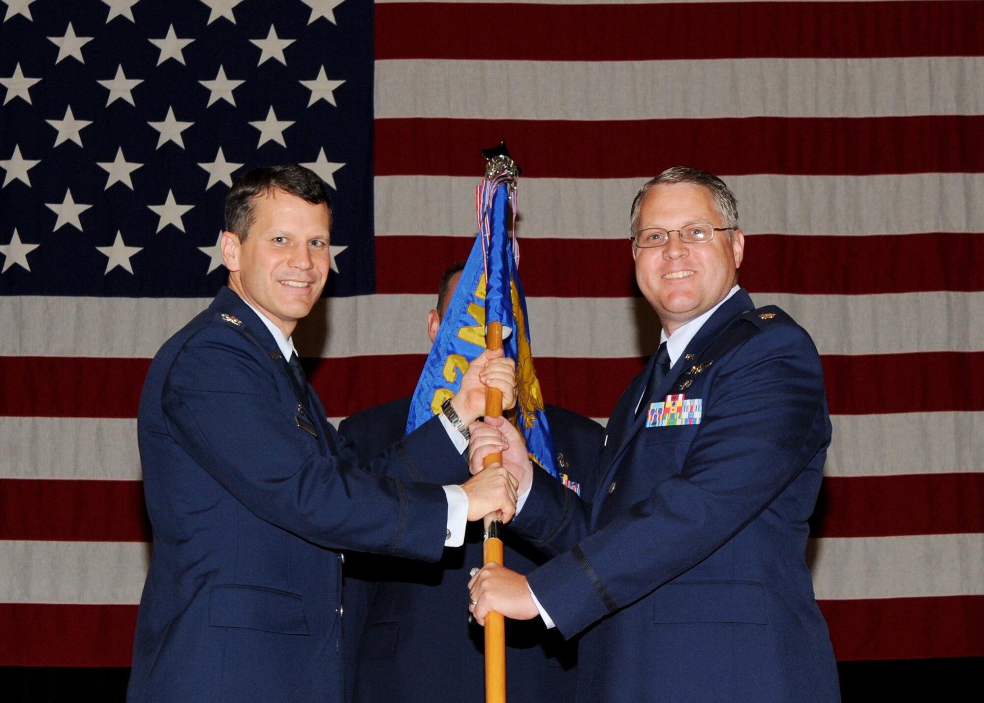 Col. Jamie Crowhurst, 22nd Air Refueling Wing commander, hands a guidon to Lt. Col. Jeffrey J. Freeland, 22nd Aerospace Medicine Squadron commander, during a change of command ceremony at the Robert J. Dole Community Center ballroom June 11, 2010, McConnell Air Force Base, Kan. The passing of the guidon symbolizes Colonel Freeland assumption of command from the outgoing 22nd AMDS commander, Col. James G. Kahrs. The AMDS is one of three squadrons in the 22nd Medical Group. The 22nd MDG is responsible for delivering quality, comprehensive medical, dental and public health care for more than 21,750 Tricare beneficiaries. (U.S. Air Force photo/ Airman 1st Class Andrea Salazar)
