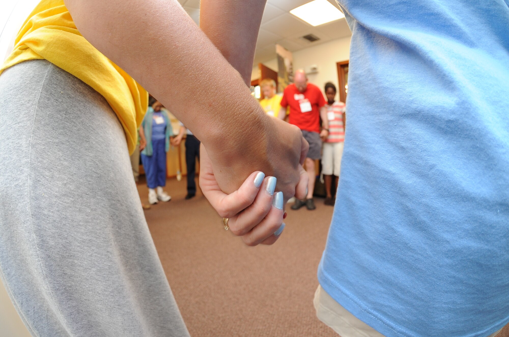 Volunteers pray before Vacation Bible School at the base chapel June 14, 2010, McConnell Air Force Base, Kan.  Vacation Bible School is one of the many events the chapel sponsors throughout the year to help enhance the spiritual readiness of Team McConnell.  More than 350 Team McConnell Airmen use the chapel weekly.  The chapel provides more than 10 opportunities for spiritual fitness throughout the week between daily mass, protestant services and “The Den,” which is an Airmen’s ministry center in dormitory building 350.  (U.S. Air Force photo/Tech. Sgt. Chyrece Campbell) 