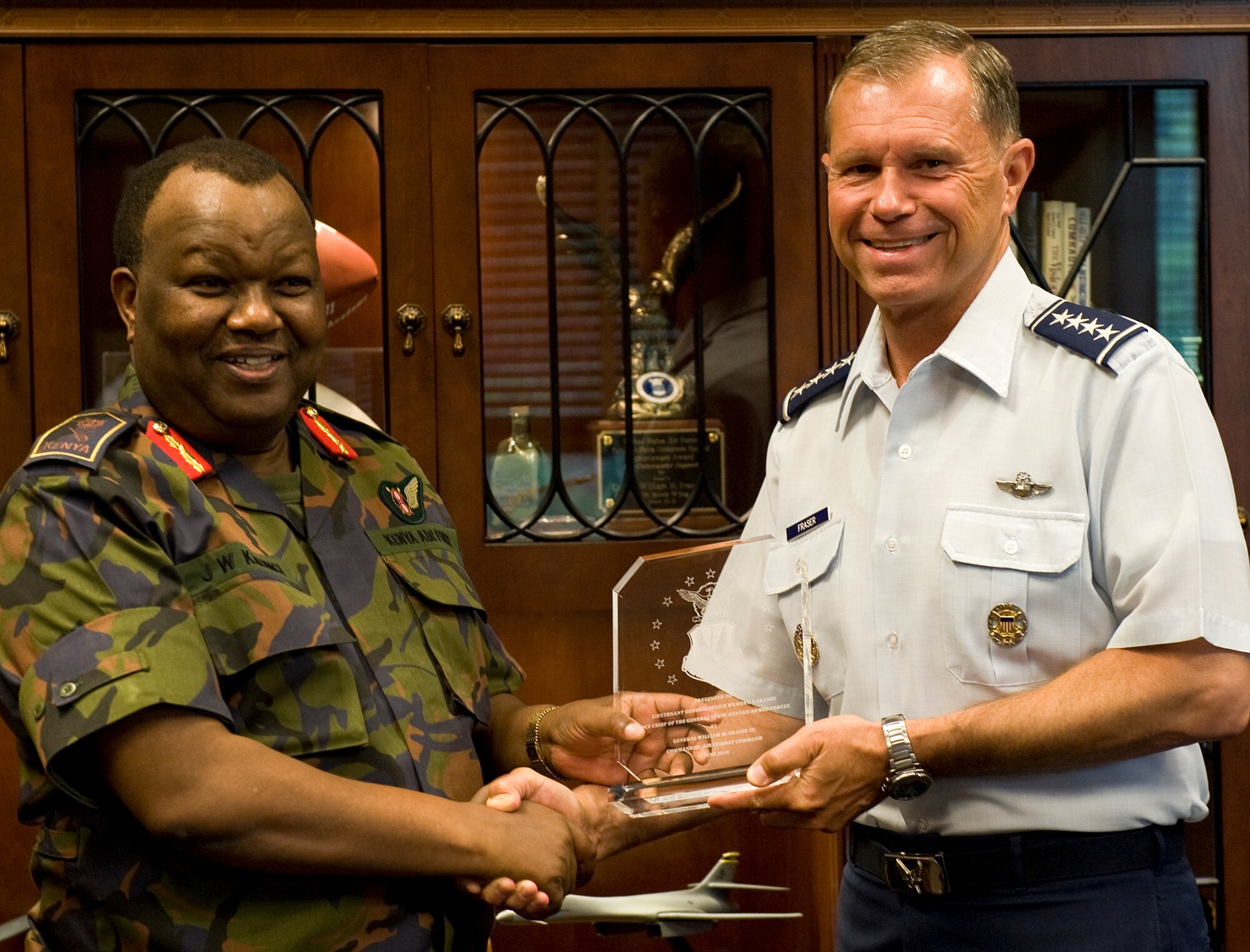 LANGLEY AIR FORCE BASE, Va. -- Gen. William M. Fraser III, Air Combat Command commander, presents a memento to Kenya Air Force Lt. Gen. Julius Waweru Karangi, Kenyan Armed Forces Vice Chief of the General Staff, June 7. Karangi visited Langley to gather a firsthand perspective of U.S. Air Force operations.  (U.S. Air Force photo/Senior Airman Zachary Wolf)
