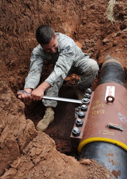 DYESS AIR FORCE BASE, Texas-- Senior Airman Francisco Sanchez, 7th Civil Engineer Squadron water/fuels system maintenance journeyman, repairs a ten inch broken jet fuel line June 14 here. 7th CES is responsible for fuel distribution that supplies aircraft on the base. 7th CES also supplies water to the entire base by continuously running water distribution systems and responding to any mishaps involving the base water system. (U.S. Air Force photo/ Airmen 1st Class Brittney Smolinski)