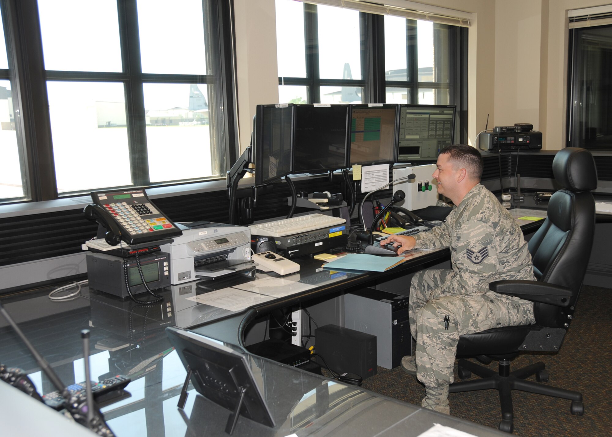 Staff Sgt. Kyle Pourcia, noncommissioned officer in charge of the fire emergency services flight, makes weather announcements in the fire control center.  (U.S. Air Force photo by Kemberly Groue)
