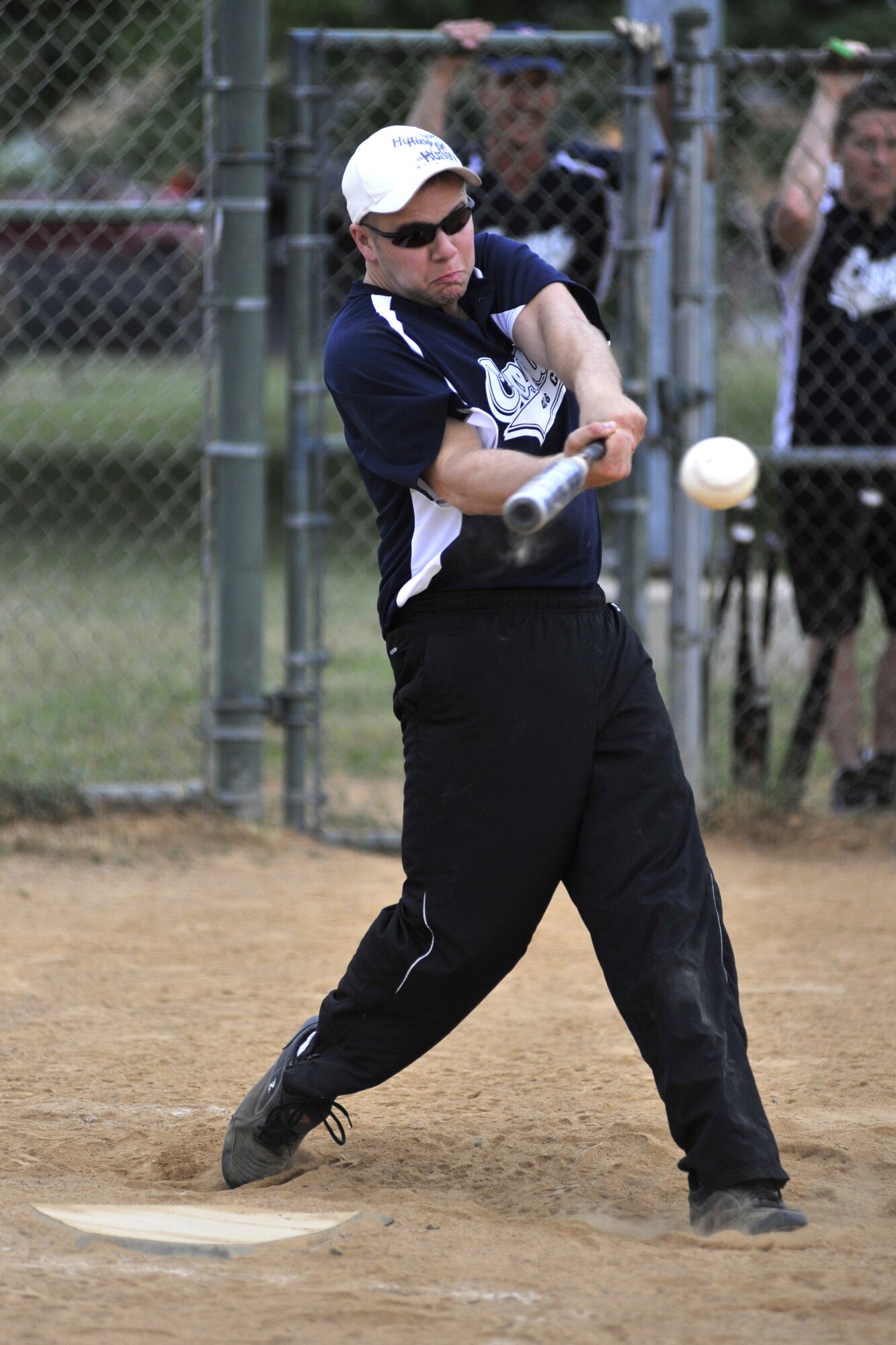 Beau Brouillette, 436th Communications Squadron catcher, raps a base hit during a National League softball game against the 436th Maintenance Squadron at the Base Softball Field on Dover Air Force Base, Del., June 15, 2010. Brouillette hit the game-winning homer in the bottom of the fifth inning to lead Comm to a 20-18 victory against MXS. (U.S. Air Force photo by Tech. Sgt. Chuck Walker/Released)