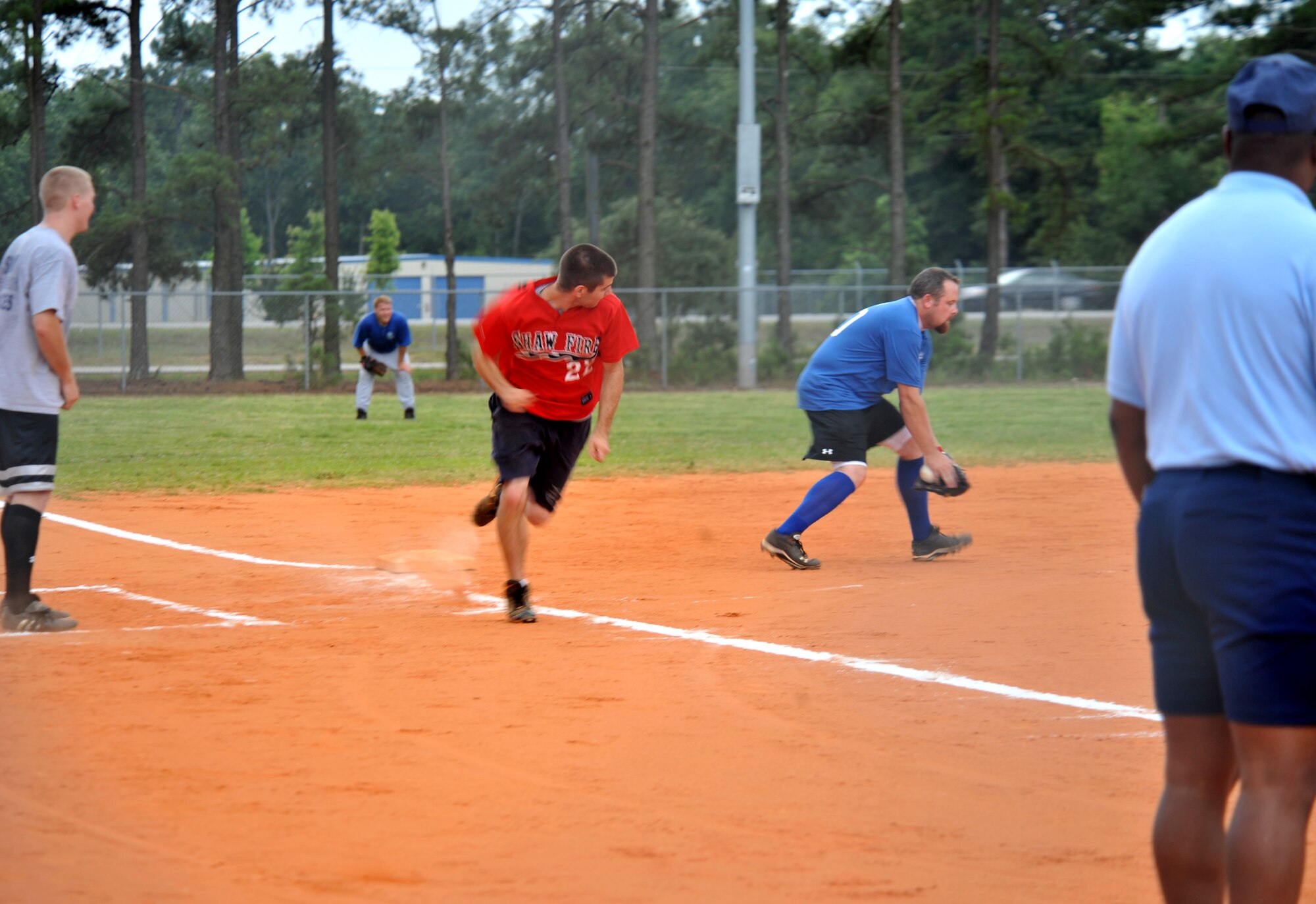 100615-F-4406D-025 SHAW AIR FORCE BASE, S.C.--   During a summer intramural softball game the 20th Security Forces Squadron versus the United States Air Force Central, Airman Justin Salzman of the 20th Civil Engineering squadron runs to home plate as the ball is thrown to the third baseman at the outdoor sports complex baseball field June 15, 2010. The game ended with the United States Air Force Central taking the win. Beginning in May, each softball team plays about 16 to 20 games during the softball season. (U.S. Air Force photo/ Airman 1st Class Tabatha L. Duarte)