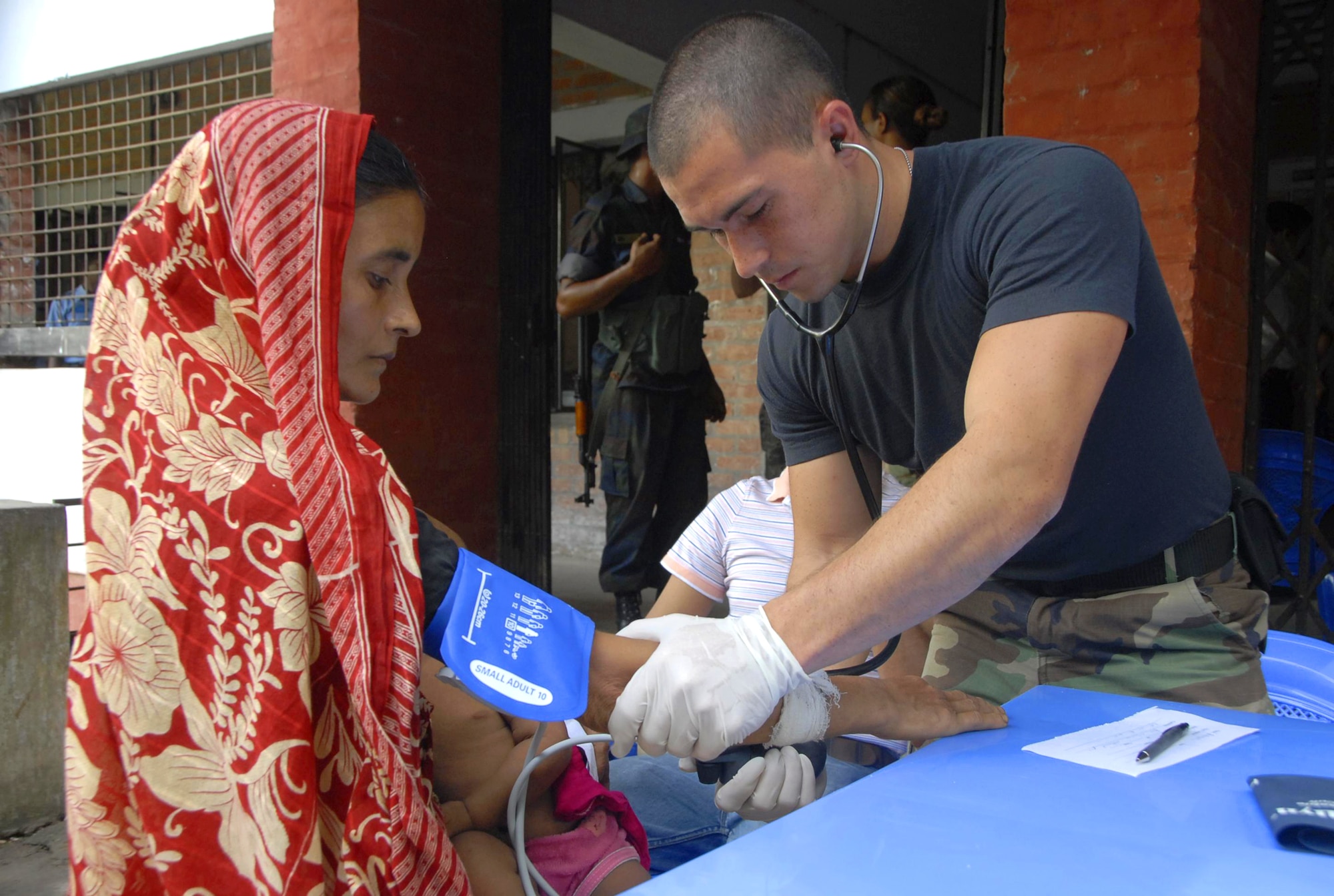 Senior Airman Josh Burns checks the blood pressure of a local Bangladeshi woman June 13, 2010, at Monirampur Regional Training Center in Jessore, Bangladesh, as part of Operation Pacific Angel. Operation Pacific Angel is a joint and combined humanitarian assistance operation conducted in the Pacific area of responsibility to support U.S. Pacific Command's capacity-building efforts. Airman Burns is a medic from 3rd Medical Operations Squadron at Elmendorf Air Force Base, Alaska,(U.S. Air Force photo/1st Lt. Chris Hoyler)