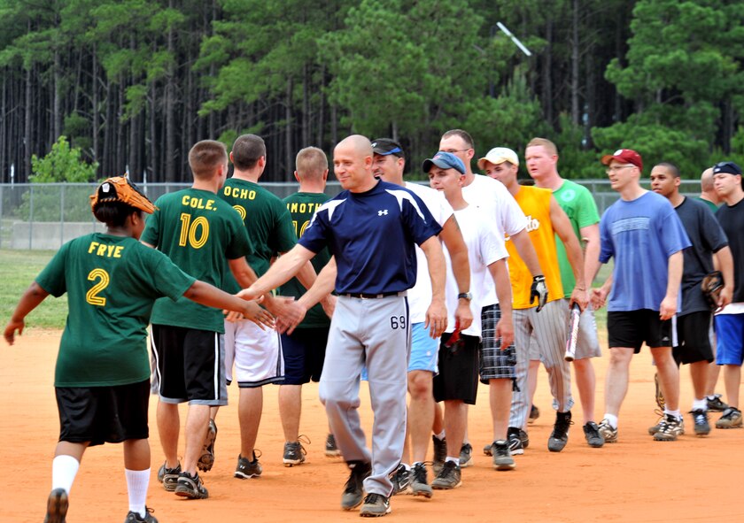 100615-F-4406D-001 SHAW AIR FORCE BASE, S.C.--   After the summer intramural softball game between the 20th Communications squadron and the 20th Component Maintenance squadron, both teams line up to congratulate one another for a good game at the outdoor sports complex baseball field June 15, 2010. The 20th CMS2 won the game. Beginning in May, each softball team plays about 16 to 20 games during the softball season. (U.S. Air Force photo/ Airman 1st Class Tabatha L. Duarte)