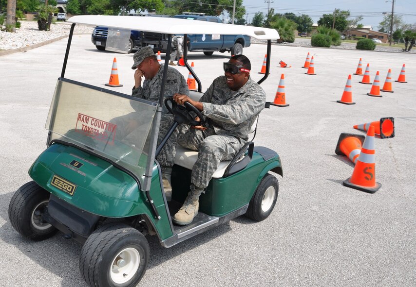 LAUGHLIN AIR FORCE BASE, Texas – Second Lt. Gregory Arrington, 47th Medical Operations Squadron, completes a driving demonstration wearing goggles that imitate a visual feeling of being drunk as Senior Airman Tyler Stoltz, 47th MDOS, rides along during an event sponsored by the ADAPT program here June 9. ADAPT is an Air Force program that provides treatment and prevention of addictions to alcohol and drugs by providing counseling and education to the Air Force community. (U.S. Air Force photo by Airman 1st Class Blake Mize)