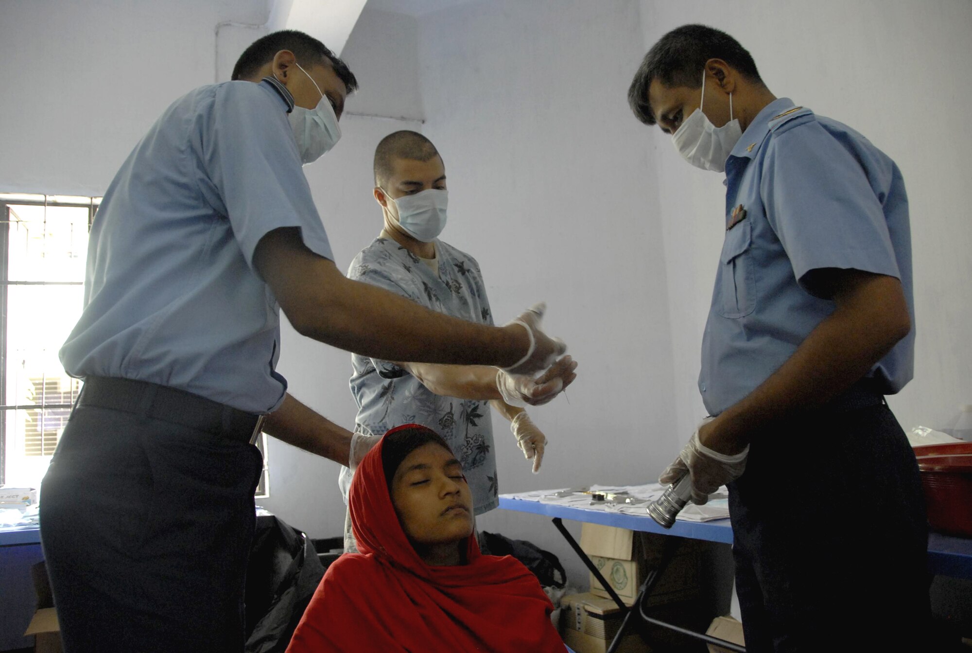 Bangladesh air force squadron leader Hannan, a dentist, receives an instrument from Staff Sgt. Michael Maldonado during Operation Pacific Angel June 13, 2010, in Jessore, Bangladesh. Operation Pacific Angel is a joint and combined humanitarian assistance operation conducted in the Pacific area of responsibility to support U.S. Pacific Command's capacity-building efforts. Sergeant Maldonado is a dental assistant from the 15th Aeromedical-Dental Squadron at Joint Base Pearl Harbor-Hickam, Hawaii. (U.S. Air Force photo/1st Lt. Chris Hoyler)