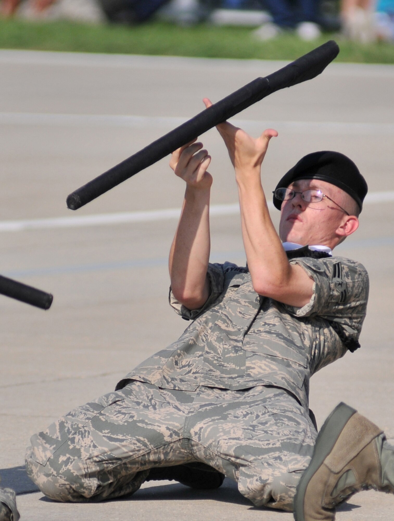 Airman 1st Class Brandon Ayres hit the ground to twirl his rifle during the 332nd TRS freestyle performance.  (U.S. Air Force photo by Adam Bond)
