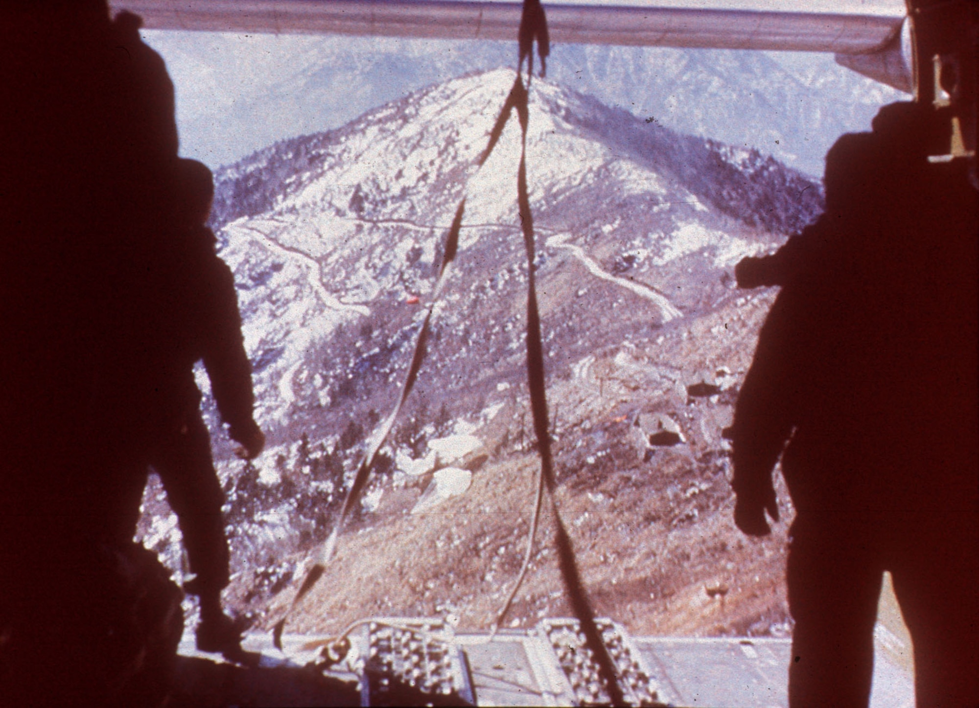 Rugged Korean terrain, seen from the back of a C-119 during a supply airdrop.  (U.S. Air Force photo)