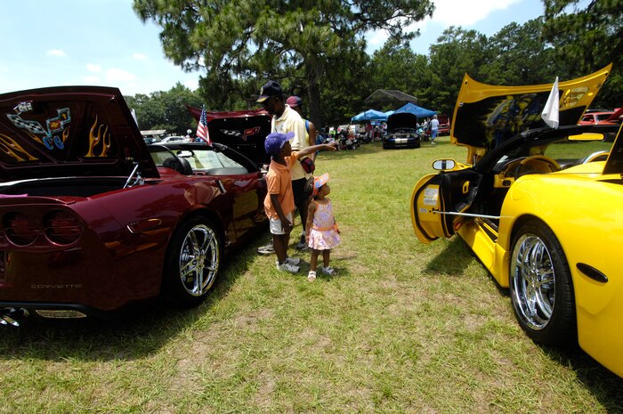 Isaac Moore and his family admire two Corvettes at the base car show on Joint Base Charleston, S.C., June 12, 2010. The two cars were in one of 10 categories at the car show, which included muscle cars, trucks and classics. More than 90 entries were submitted from car enthusiasts around South Carolina. Isaac Moore is a retired U.S. Air Force captain. (U.S. Air Force Photo/Airman 1st Class Lauren Main)