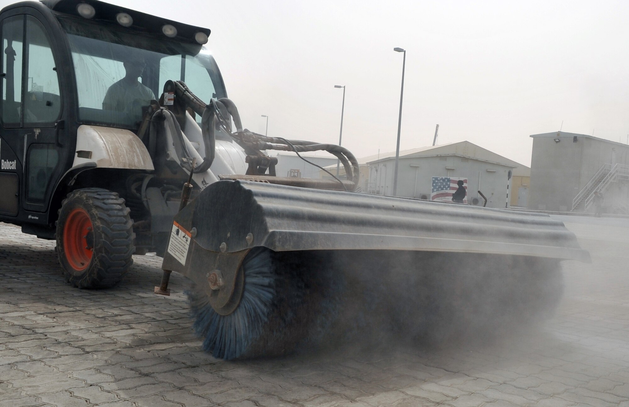 Airman 1st Class James Oldenhoff, pavements and construction equipment journeyman with the 380th Expeditionary Civil Engineer Squadron, uses a sweeper to clean an area of the 380th Air Expeditionary Wing compound at a non-disclosed base in Southwest Asia on June 12, 2010. Airman Oldenhoff is deployed from the 786th Civil Engineer Squadron at Ramstein Air Base, Germany, and his hometown is Wisconsin Dells, Wisc. (U.S. Air Force Photo/Master Sgt. Scott T. Sturkol/Released)
