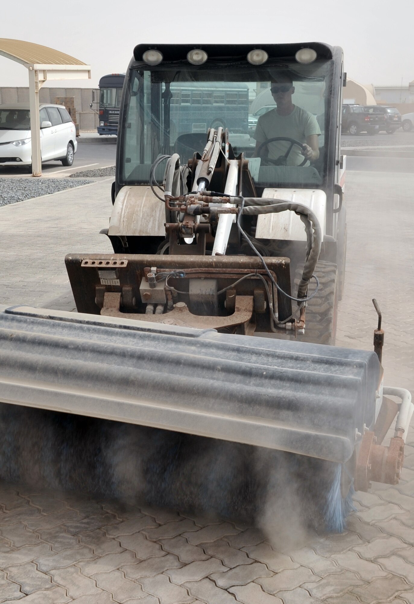 Airman 1st Class James Oldenhoff, pavements and construction equipment journeyman with the 380th Expeditionary Civil Engineer Squadron, uses a sweeper to clean an area of the 380th Air Expeditionary Wing compound at a non-disclosed base in Southwest Asia on June 12, 2010. Airman Oldenhoff is deployed from the 786th Civil Engineer Squadron at Ramstein Air Base, Germany, and his hometown is Wisconsin Dells, Wisc. (U.S. Air Force Photo/Master Sgt. Scott T. Sturkol/Released)