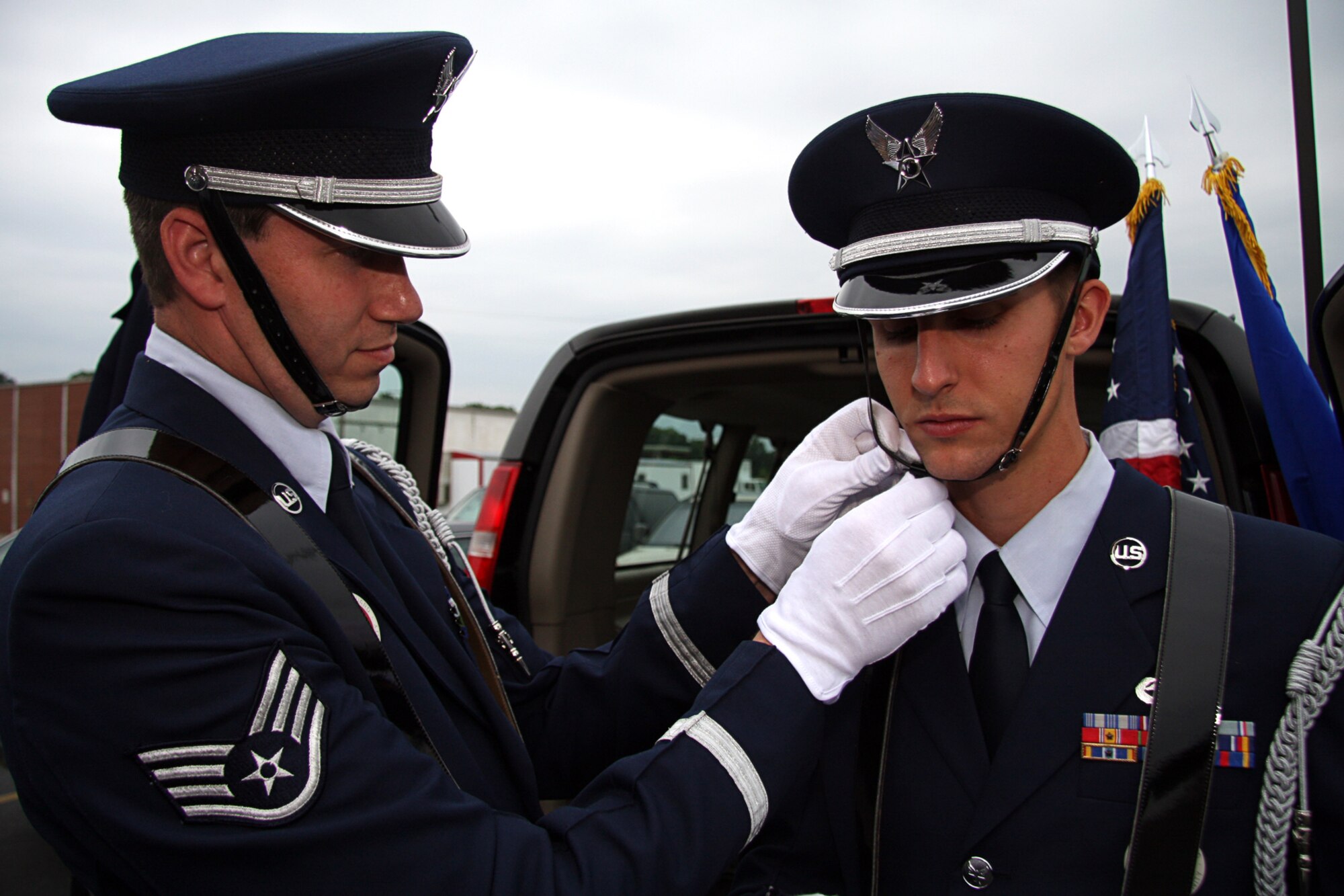 GRISSOM AIR RESERVE BASE, Ind. -- Staff Sgt. Ben Durr, left, adjusts a chin strap for Staff Sgt. Anthony Abney prior to their performance at an opening ceremony for a Veteran's Affairs outpatient clinic June 8. Both sergeants are members of the Grissom Base Honor Guard. Ceremonial Guardsmen pay special attention to not only performance but also uniformity. Each ceremonial uniform is inspected prior to each detail to make sure everything is perfect. (U.S. Air Force photo/Tech. Sgt. Mark R. W. Orders-Woempner)