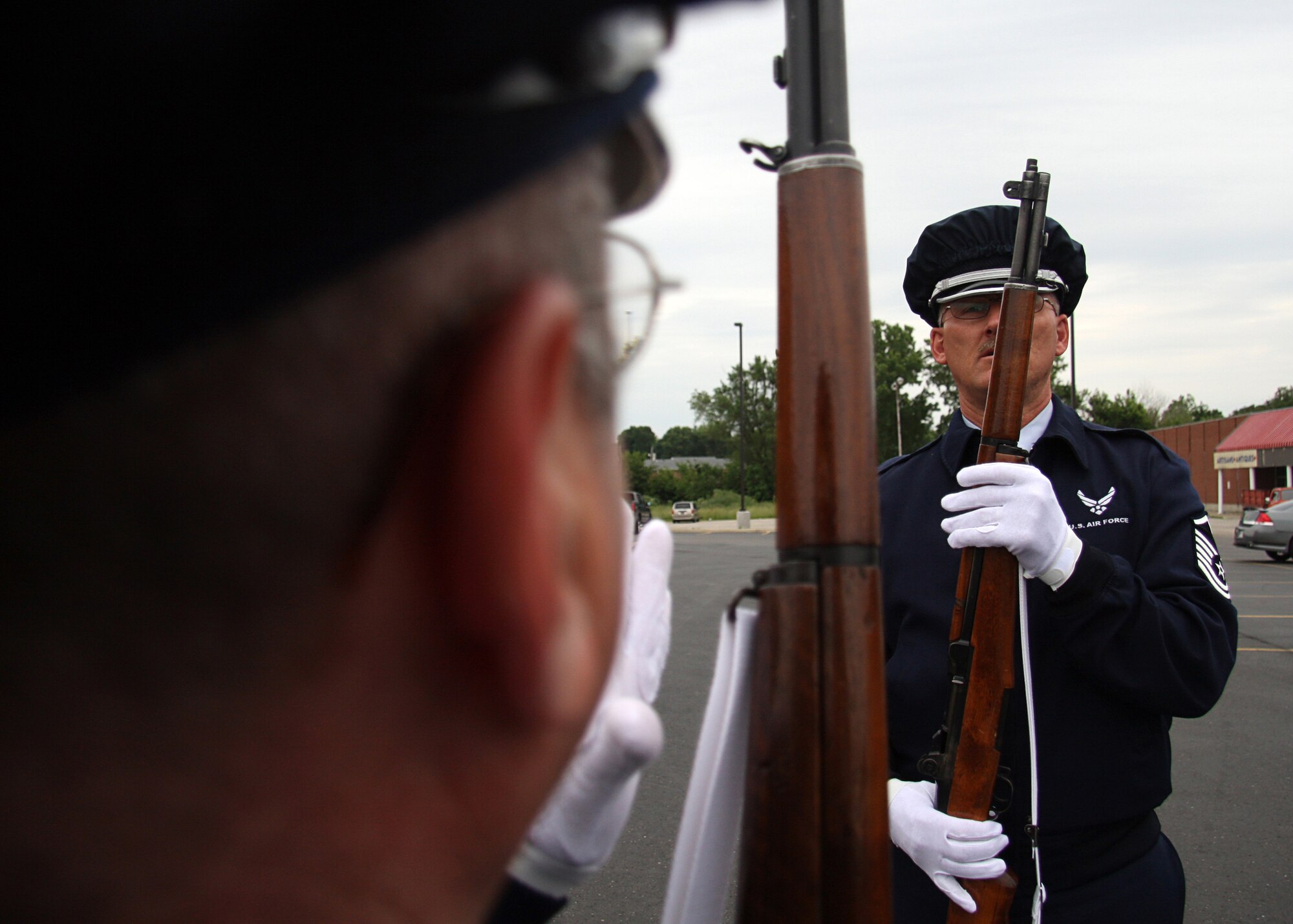 GRISSOM AIR RESERVE BASE, Ind. -- Tech. Sgt. David Kirk, foreground, and Master Sgt. Tim Wood go over rifle drill procedures prior to posting the Colors at a new Veteran's Affairs outpatient clinic that opened June 8. Both sergeants are members of the Grissom Base Honor Guard, which often goes into the local communities and performs various ceremonies representing the Department of the Air Force and Grissom. (U.S. Air Force photo/Tech. Sgt. Mark R. W. Orders-Woempner)