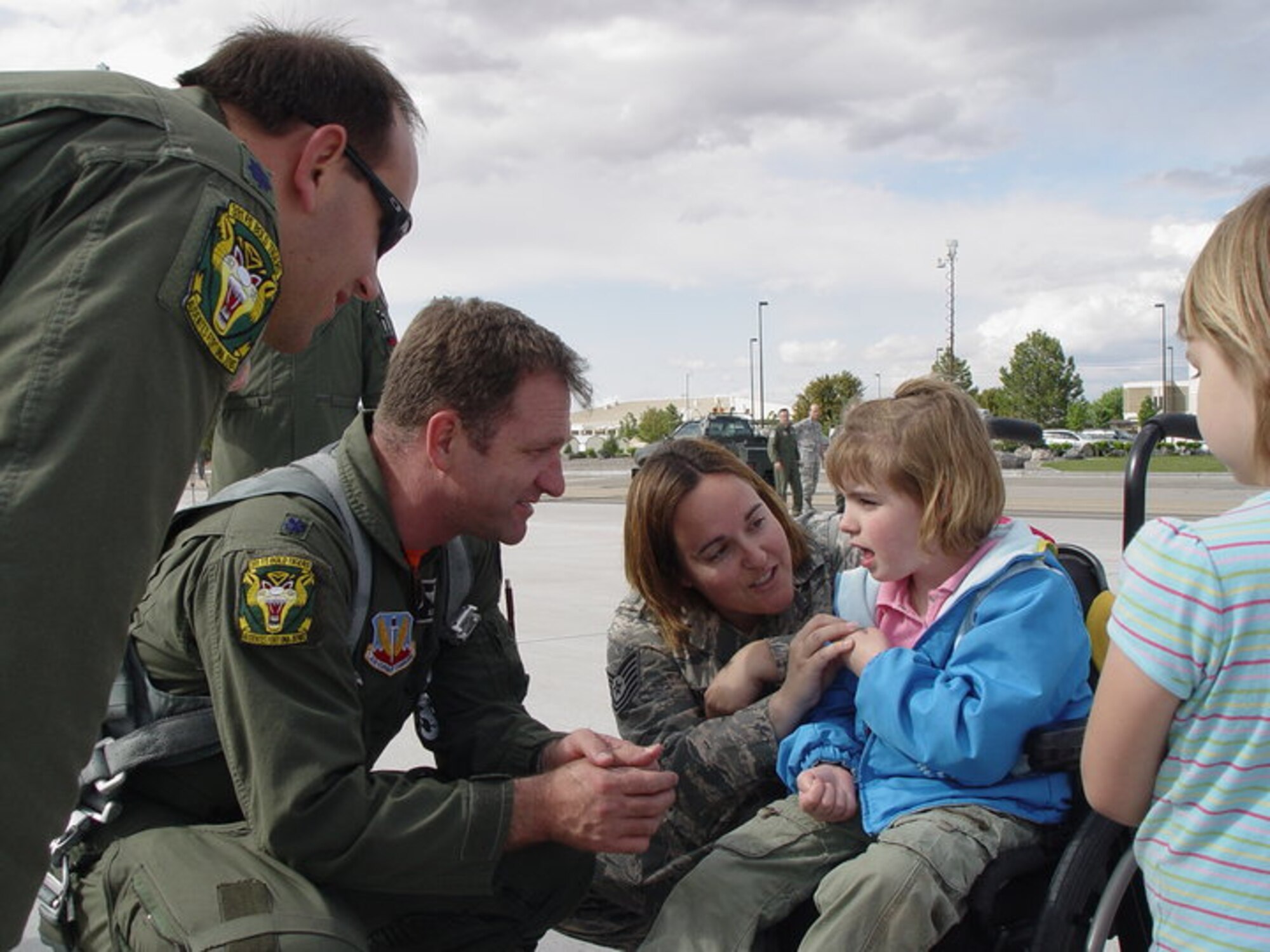 MOUNTAIN HOME AIR FORCE BASE, Id -- Lt. Col. Mark H. Slocum, commander of the 391st Fighter Squadron, coins Mackenzie Smith, daughter of Tech Sgt. Maria Smith, who suffered a traumatic brain injury in February 2009. Slocum coined Mackenzie on May 21st during Col. Bird’s fini flight ceremony.(Courtesy Photo)