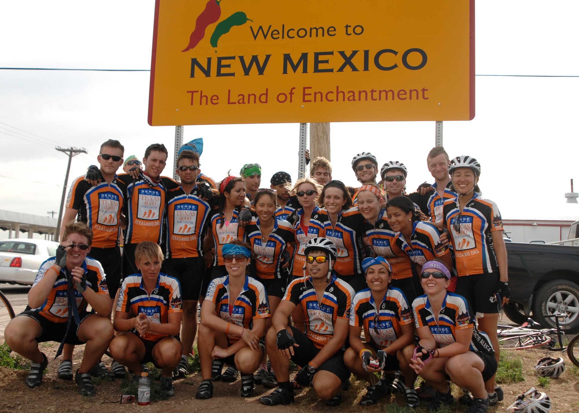 Texas 4000 riders, a cancer fundraising group from the University of Texas at Austin, gather for a group photo at the New Mexico border on June 10. Cannon Air Force Base Air Commandos hosted the cyclists for the evening before they continued their journey to Anchorage, Alaska. (U.S. Air Force photo by Greg Allen) 
