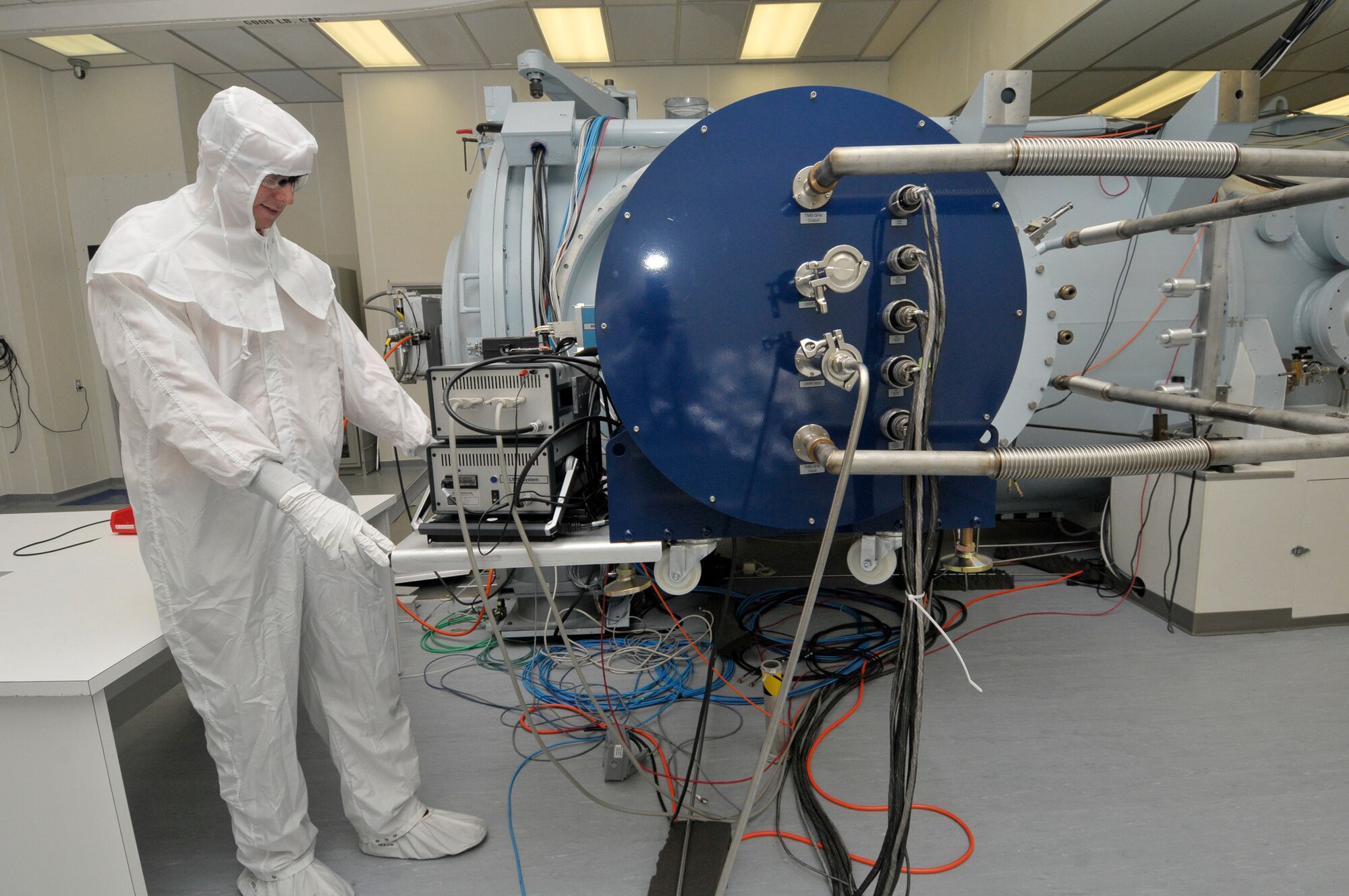 Brandon Stiles, deputy director for the 650th Test Evaluation Systems Squadron, examines the data setup for the new Target Monitoring System (TMS) that is shown here in the 7V Space Chamber’s clean room. He managed the renovation of 7V’s clean room approximately four years earlier. (Photo by Rick Goodfriend)

