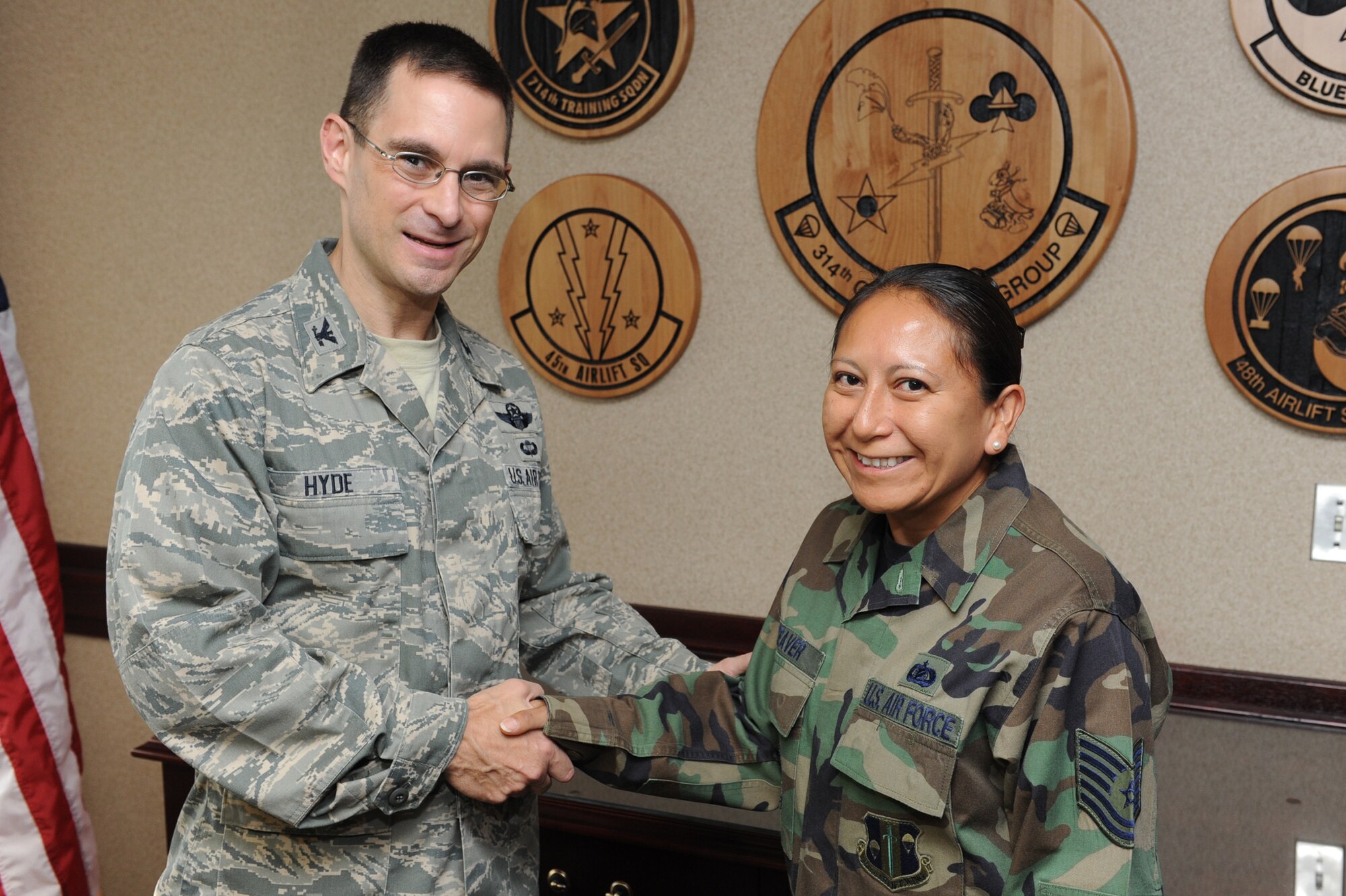 Col. C. K. Hyde, 314th Airlift Wing commander, presents a coin June 16 to Tech. Sgt. Cassandra Beaver, 314th Operations Group knowledge operations NCO-in-charge, for her selection as the Combat Airlifter of the Week. Sergeant Beaver executed 328 sets of TDY orders and associated travel vouchers worth $63,400 and maintained 100 percent travel voucher completion rate for the 314th OG staff departure. (U.S. Air Force photo by Senior Airman Ethan Morgan)