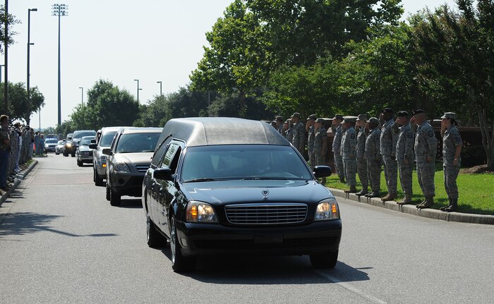 The remains of a U.S. Army noncommissioned officer are transported down the main thoroughfare of Joint Base Charleston, S.C., mid-morning June 11, 2010, as the Airmen lining the street salute the fallen comrade. U.S. Army honor guard members from Fort Jackson, S.C., received the remains upon arrival to JB CHS. (U.S. Air Force photo/James M. Bowman)