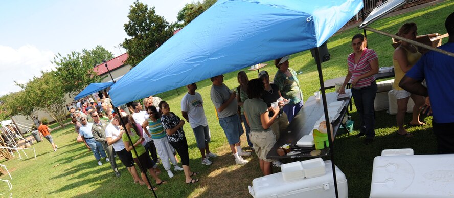 BARKSDALE AIR FORCE BASE, La. – Barksdale Airmen and their families form line up for a plate of crawfish during the Barksdale Crawfish Festival June 11. There were approximately 500 people that attended the festival and more than 700 pounds crawfish boiled. (U.S. Air Force photo by Senior Airman Alexandra M. Boutte) (RELEASED)