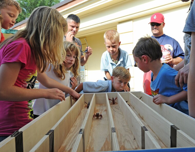 BARKSDALE AIR FORCE BASE, La. – Several children line up and race their chosen crawfish during the Barksdale Crawfish Festival June 11. The crawfish could be not be touched during the race but could be blown or redirected. (U.S. Air Force photo by Senior Airman Alexandra M. Boutte) (RELEASED)