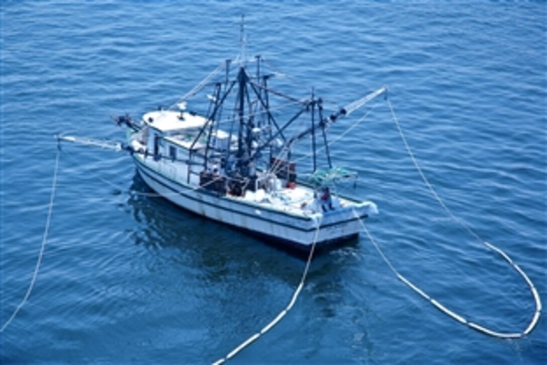 The New Horizon sets up its oil-skimming equipment as it prepares to assist in the Gulf of Mexico outside Mobile Bay, Ala., June 13, 2010. The boat is part of the Vessel of Opportunity program, designed to enable local boat operators to assist with response activities. 