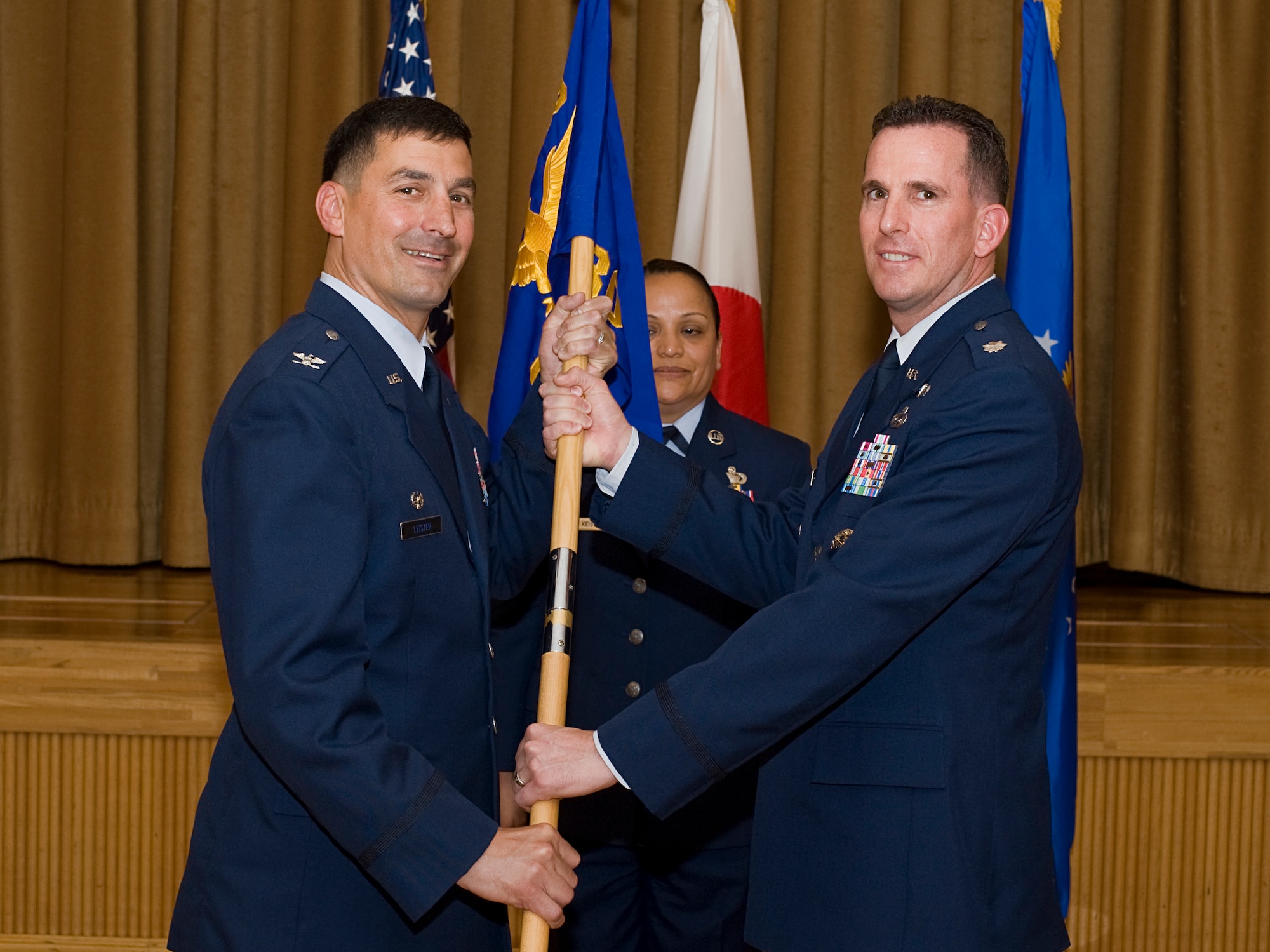 MISAWA AIR BASE, Japan -- Lt. Col. Michael Smith receives the 301st Intelligence Squadron guidon from Col. Barry Leister, 373rd Intelligence, Surveillance and Reconnaissance Group commander, during a change of command ceremony June 17 at the Collocated Club. Colonel Smith assumed command of the 301st IS from Lt. Col. Kurt Gaudette. Colonel Smith comes from Headquarters U.S. Air Force, Washington, D.C., where he served as the executive director for the director of Intelligence, Surveillance and Reconnaissance Resources. (U.S. Air Force photo/Senior Airman Jamal D. Sutter)