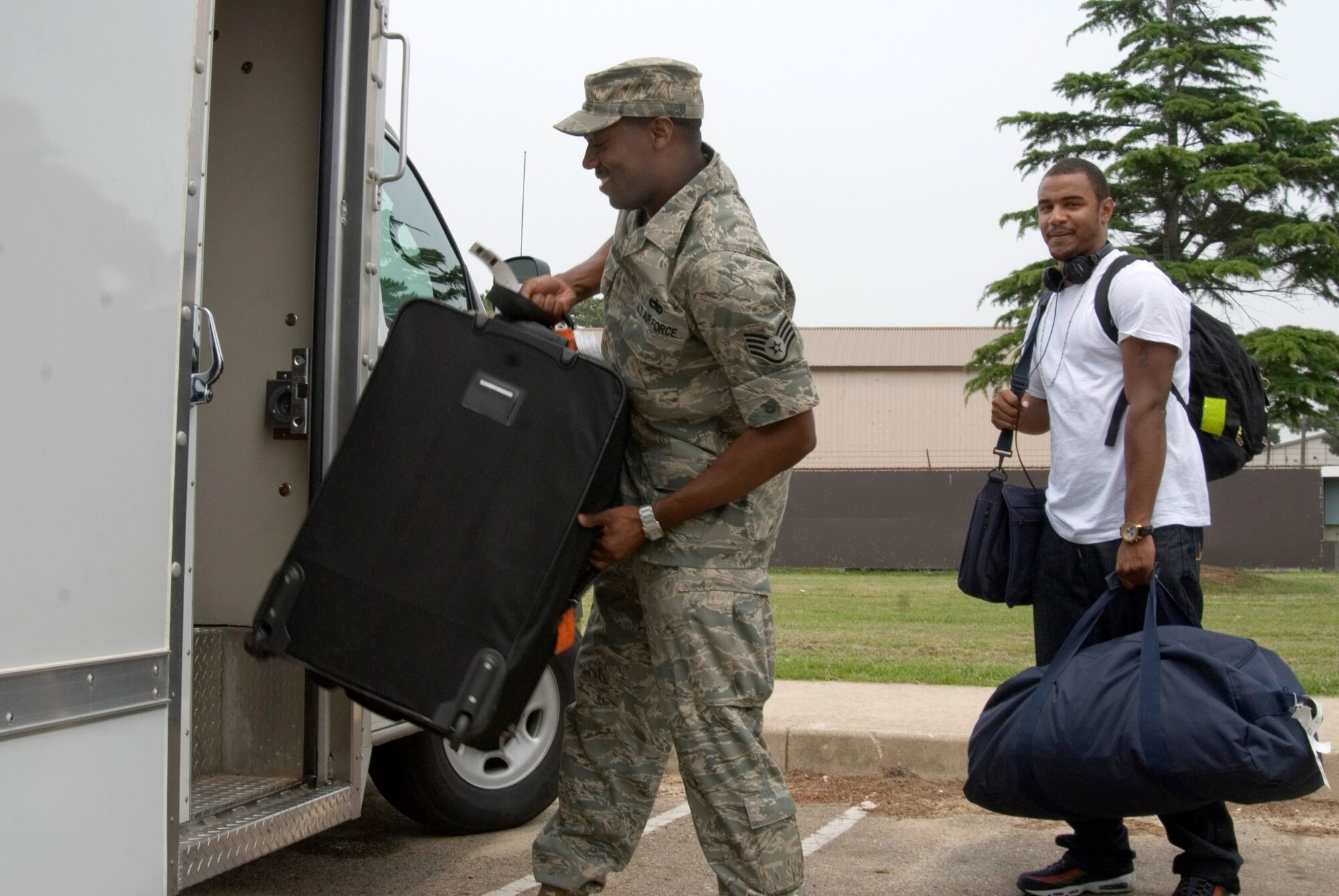 KUNSAN AIR BASE, Republic of Korea -- Staff Sgt. Reginald Hill, 8th Maintenance Squadron aircraft fuel systems craftsman, assists Senior Airman Cortez Brazill with his luggage after arriving on the Patriot Express.  Sergeant Hill is Senior Airman Brazill's sponsor and first impression of the Wolf Pack. Being a good sponsor is a simple process, thanks to the sponsorship program provided by the Airman and Family Readiness Center. The AFRC provides many services to equip Airmen with the skills and information needed to be a good sponsor. Senior Airman Brazill was previously stationed at Aviano Air Base, Italy. (U.S. Air Force photo/Staff Sgt. Jonathan Pomeroy)