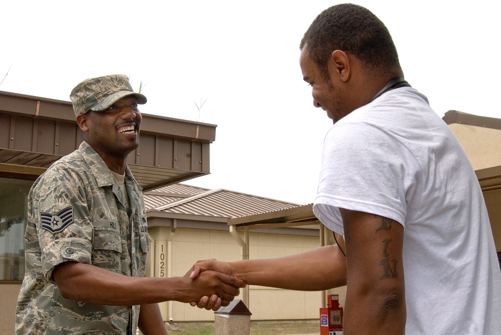 KUNSAN AIR BASE, Republic of Korea -- Staff Sgt. Reginald Hill, 8th Maintenance Squadron aircraft fuel systems craftsman, greets Senior Airman Cortez Brazill shortly after he arrived on base via the  Patriot Express.  Sergeant Hill is Senior Airman Brazill's sponsor and first impression of the Wolf Pack. Being a good sponsor is a simple process, thanks to the sponsorship program provided by the Airman and Family Readiness Center. The AFRC provides many services to equip Airmen with the skills and information needed to be a good sponsor. Senior Airman Brazill was previously stationed at Aviano Air Base, Italy. (U.S. Air Force photo/Staff Sgt. Jonathan Pomeroy)