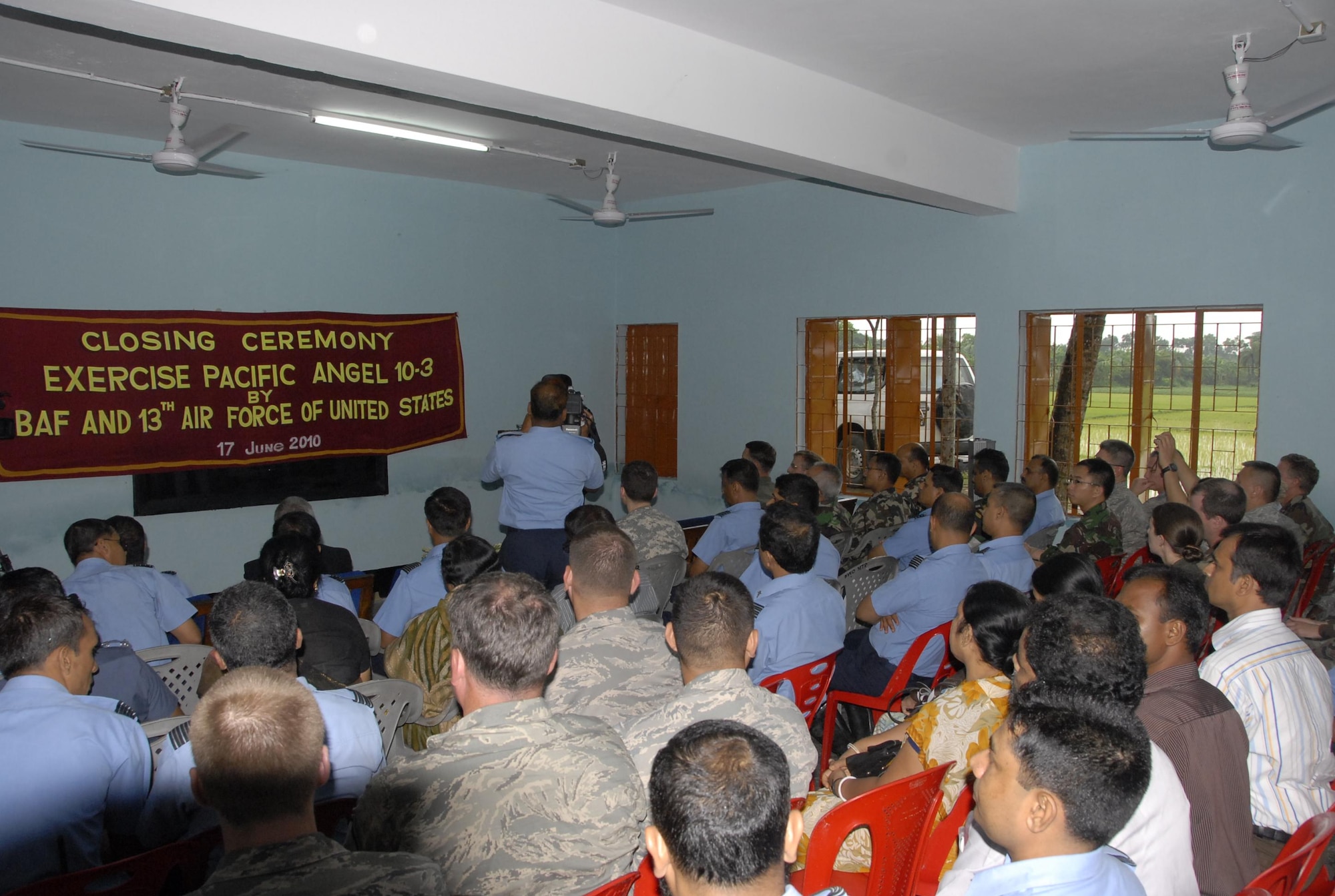 Participants in Pacific Angel 10-3 look on during the closing ceremony of the operation June 17 at the Lauri High School in Jessore, Bangladesh. The ceremony took place in one of the many buildings renovated at the school; renovations included new fans, light fixtures and interior and exterior paint jobs. More than 55 U.S. military personnel executed five days of civil assistance programs with the help of the Bangladesh Air Force, Indonesian Air Force, Nepalese Army and local nongovernmental organizations. (U.S. Air Force photo by 1st Lt. Chris Hoyler)