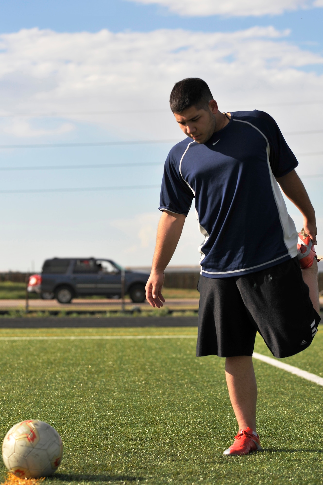 BUCKLEY AIR FORCE BASE, Colo. -- Airman 1st Class Nolan Luna-Chavez,460th Space Communication Squadron, stretches before doing a few practice drills. Airman Luna-Chavez has been playing soccer since the 7th grade. (U.S. Air Force photo by Airman 1st Class Paul Labbe)