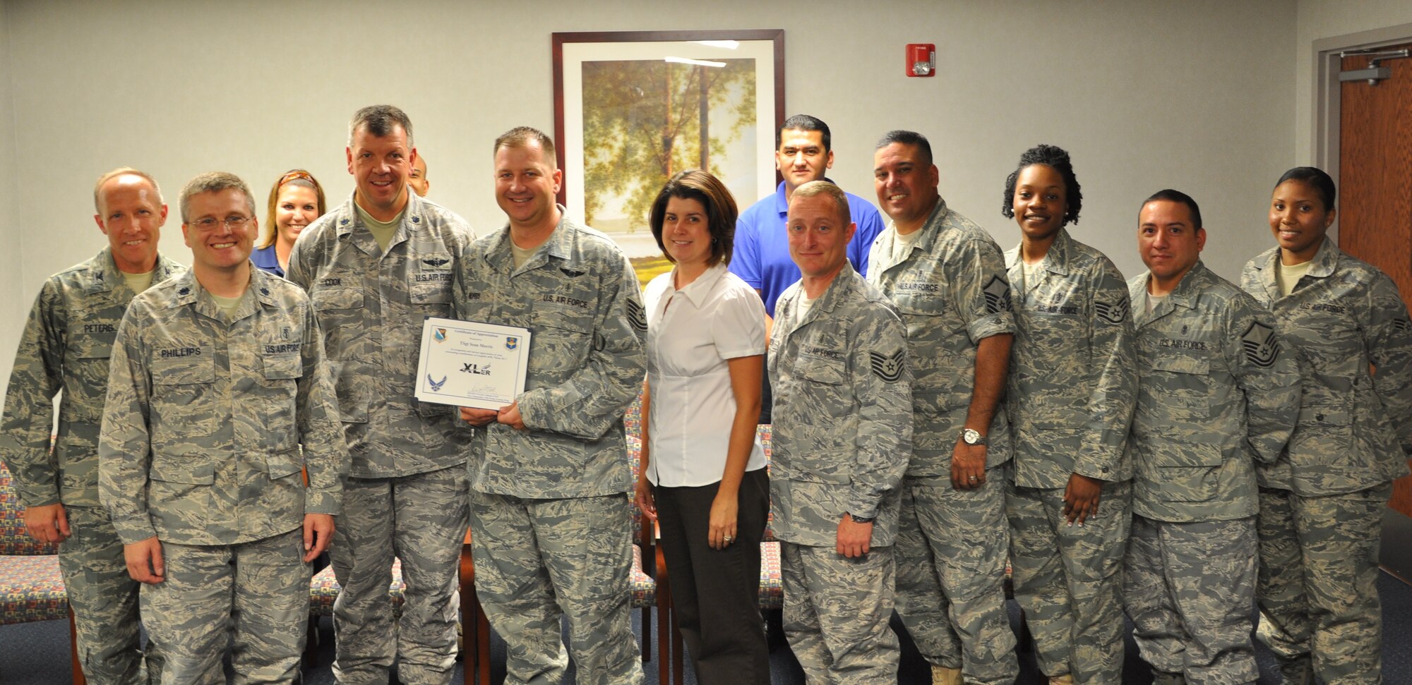 LAUGHLIN AIR FORCE BASE, Texas –Tech. Sgt. Sean Morris, 47th Medical Operations Squadron , poses with fellow members of his squadron after being presented the XLer of the Week award by Col. David Ellis, 47th Flying Training Wing vice commander, June 16. The XLer is a weekly award chosen by 47th FTW leadership and given to individuals who consistently make outstanding contributions to Laughlin and their unit. (U.S. Air Force photo by Airman 1st Class Blake Mize)