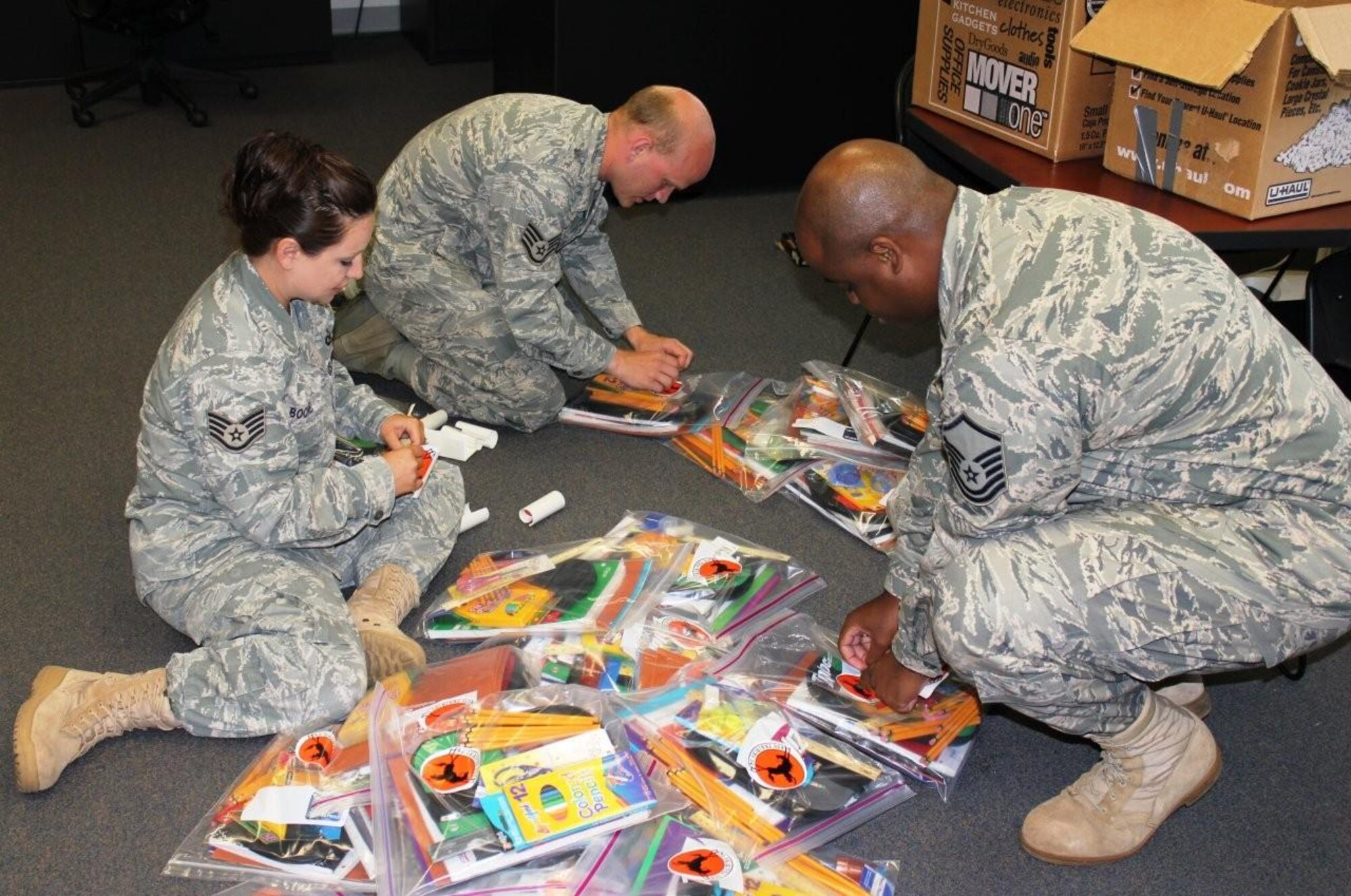 DYESS AIR FORCE BASE, Texas-- Members of the 436th Training Squadron assemble packages filled with donated school supplies for the Operation Iraqi Children program June 4 here. The program aids Iraqi schools and families who do not have access to basic academic supplies or equipment. Operation Iraqi Children is a charity effort founded in 2004 by actor Gary Sinise and author Laura Hillenbrand. (U.S. Air Force photo/ Master Sgt. Mark Hazelbaker)