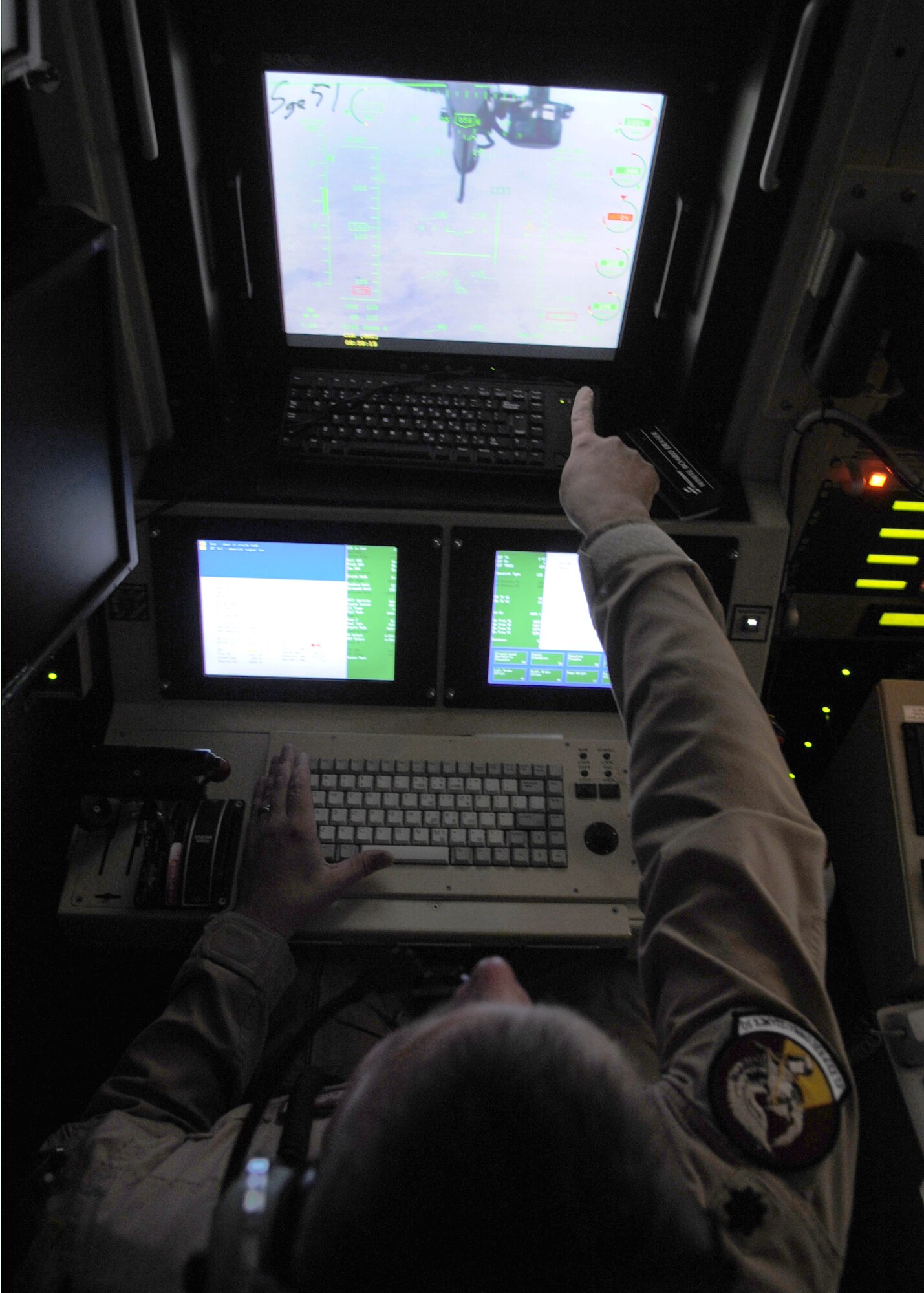 Lt. Col. James Curry remotely pilots the MQ-9 Reaper June 8, 2010, at Kandahar Airfield, Afghanistan. The remotely piloted aircraft are launched, recovered and landed by members of the 62nd Expeditionary Reconnaissance Squadron. Colonel Curry is the 62nd ERS commander. (U.S. Air Force photo/Senior Airman Nancy Hooks)
