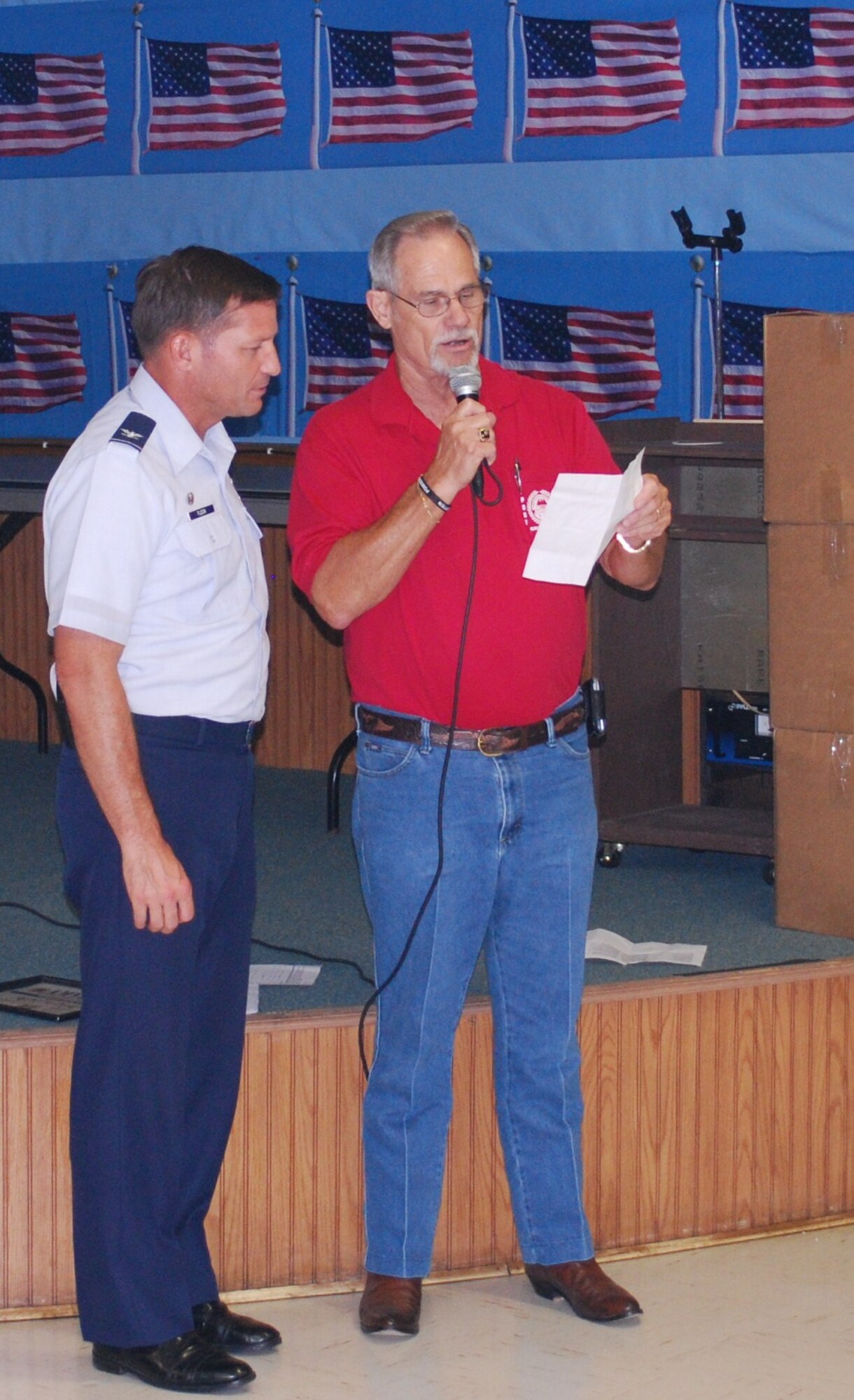 Rocky Bradford, American Veterans commander, presents Col. Michael Fleck, 325th Mission Support Group commander, donated clothing for deployed military members June 7 at the AMVETS Post 2298.  In total, 350 articles of clothing were given during the exchange.  (Courtesy photo)