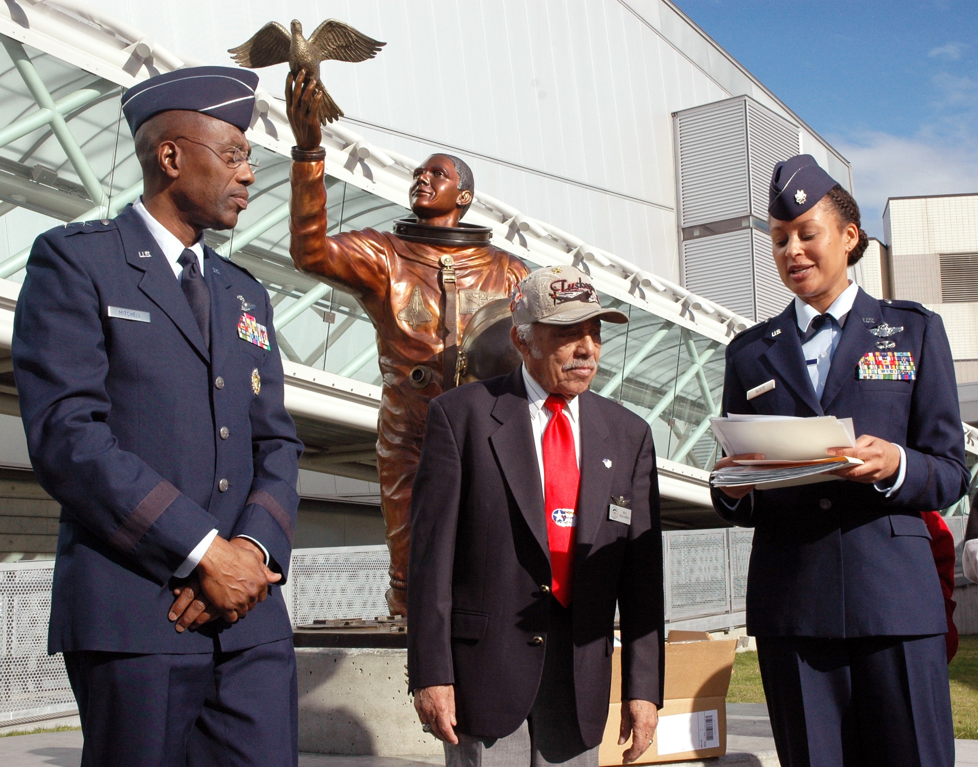 Maj. Gen. Harold L. "Mitch" Mitchell, Tuskegee Airman Retired Lt. Col. Bill Holloman and Lt. Col. Kimberly Scott prepare to present certificates to students as part of the Michael Anderson Memorial Scholarship event at Seattle's Museum of Flight. Colonel Holloman is one of the famed "Tuskegee Airmen" who broke the military's color barrier by becoming a World War II fighter pilot. He died June 11, 2010, in Kent, Wash. General Mitchell is the Deputy Inspector General of the Air Force, in Washington D.C. (U.S. Air Force photo/Staff Sgt. Elizabeth Moody)