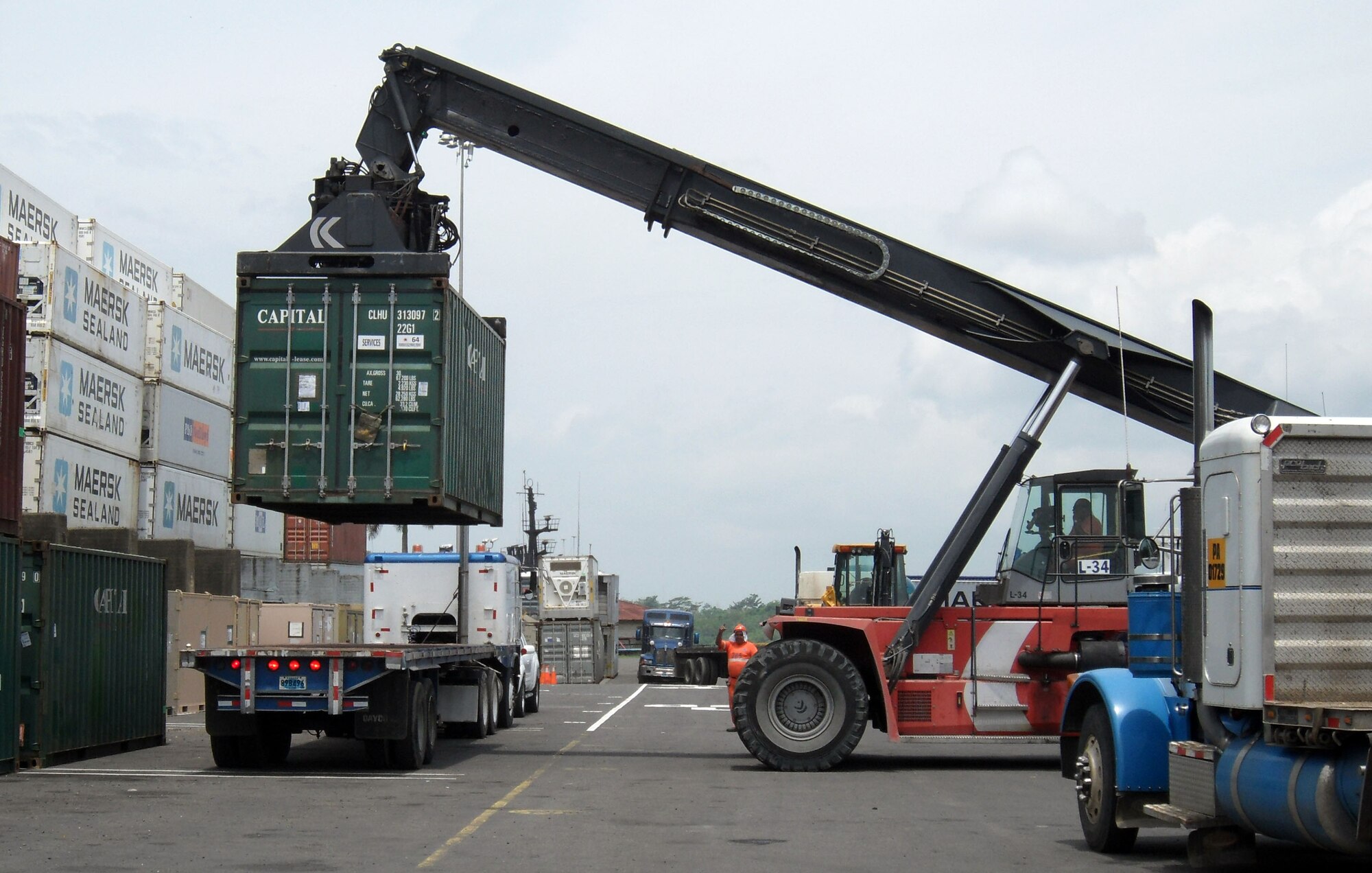 Airmen load cargo containers onto a flatbed truck at the the Panama City port in support of New Horizons Panama 2010, a 12-week humanitarian assistance mission. More than 250 Airmen, Soldiers and Marines will deploy to six constructions sites and five mecical missions in Panama. (U.S. Air Force photo/Staff Sgt. Teresa Burger)