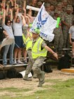 Airman 1st Class Aaron Brown, 344th Training Squadron, fires up the crowd during the 37th Training Group drill team competition June 12 at the Air Force Basic Military Training drill pad. (U.S. Air Force photo/Robbin Cresswell)