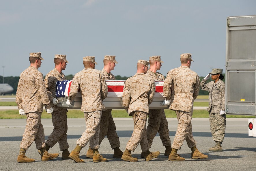10 June 2010  USAF Photo by Jason Minto.  A U.S. Marine Corps carry team transfers the remains of Marine SGT Derek Shanfield of Hastings, PA., at Dover Air Force Base, Del., June 10, 2010.  